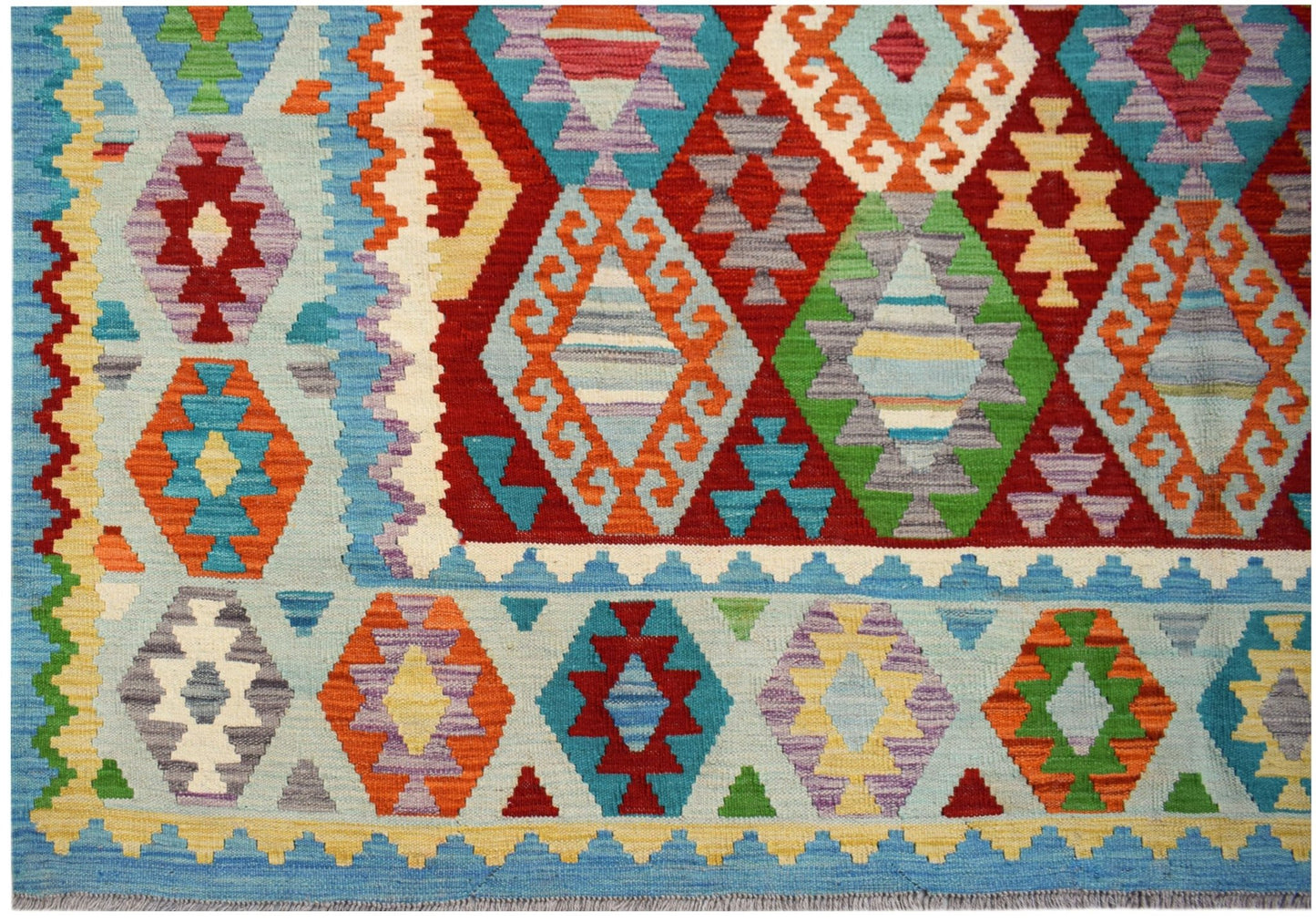 Handwoven Afghan Maimana Kilim rug featuring a vibrant geometric pattern in wool.