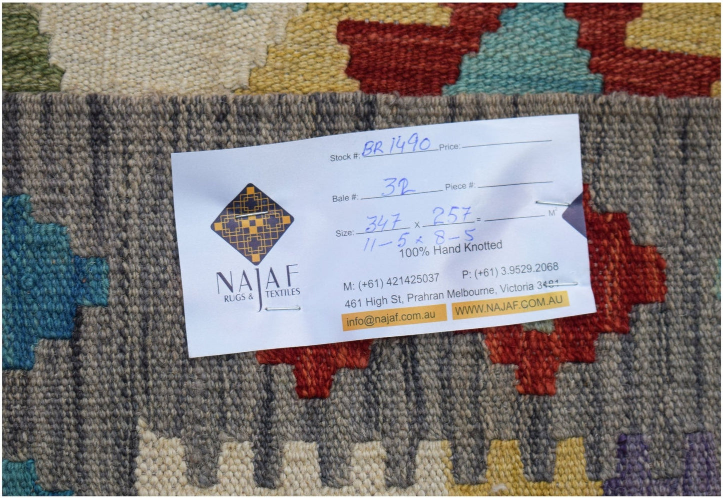 A handwoven Afghan Maimana Kilim featuring a colorful geometric pattern and flatweave texture.