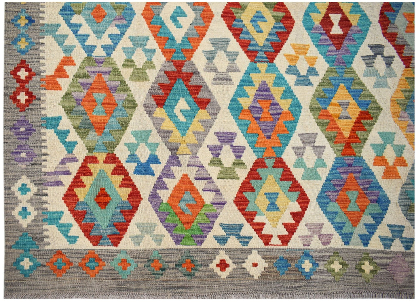 Handwoven Afghan Maimana kilim featuring a vibrant geometric diamond pattern in wool.