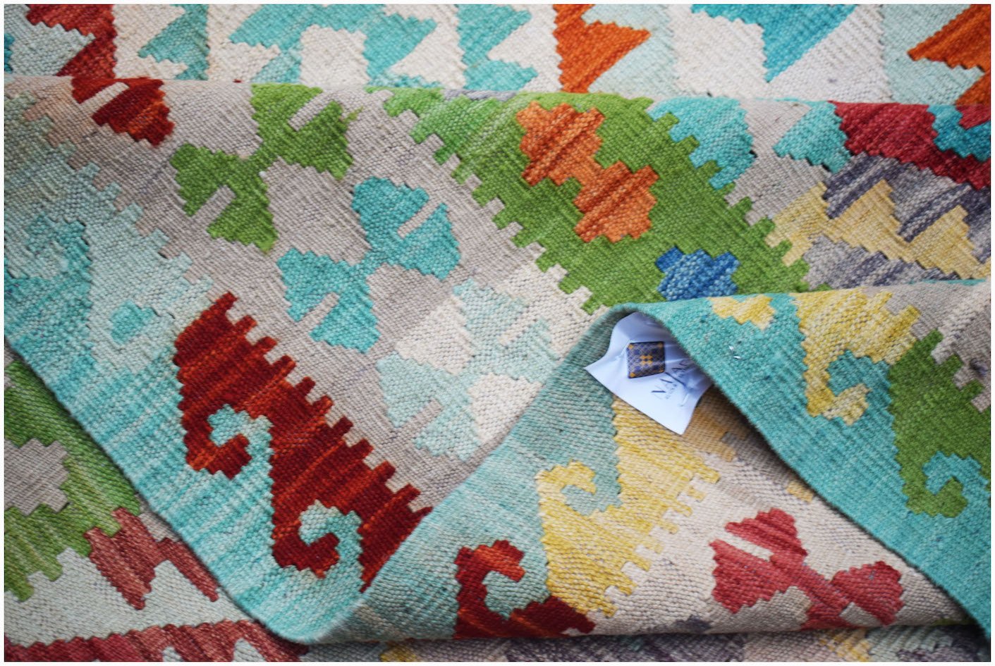Afghan Maimana Kilim with geometric patterns in red, green, blue, and yellow.