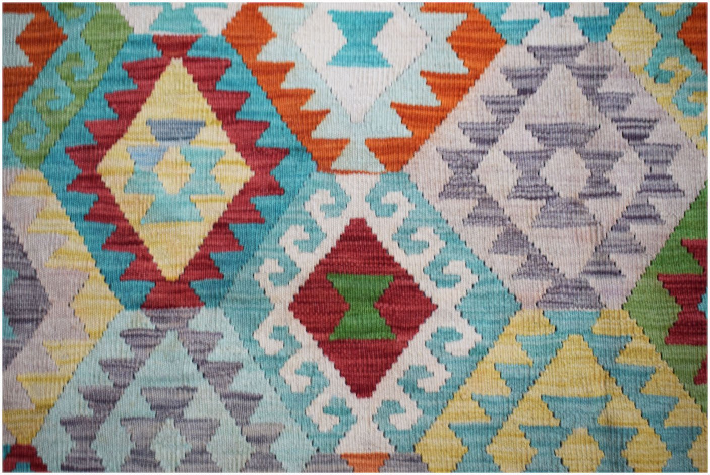 Handwoven Afghan Maimana kilim rug featuring a vibrant geometric diamond pattern in wool.