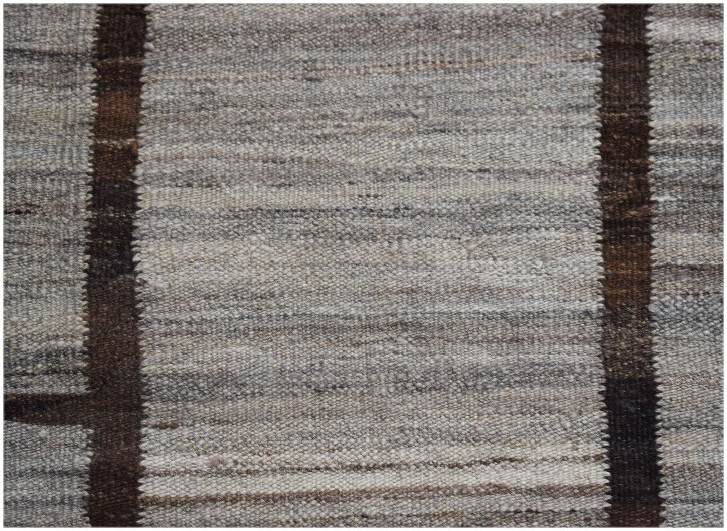 Afghan Maimana Kilim with vertical brown stripes on a textured grey background.