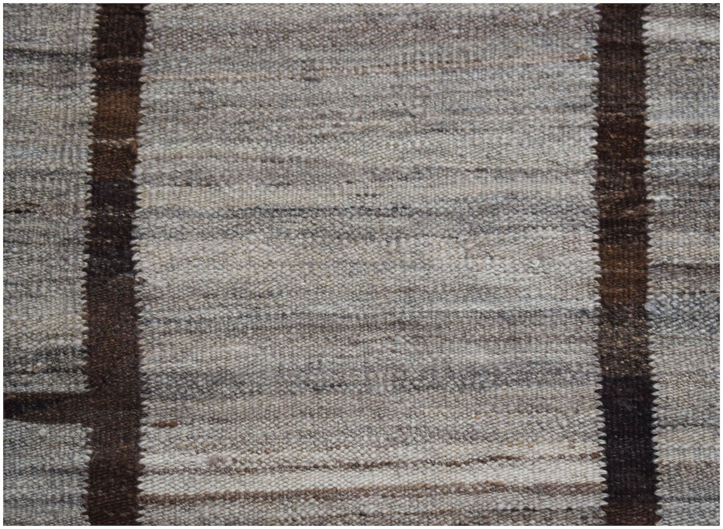 Afghan Maimana Kilim with vertical brown stripes on a textured grey background.