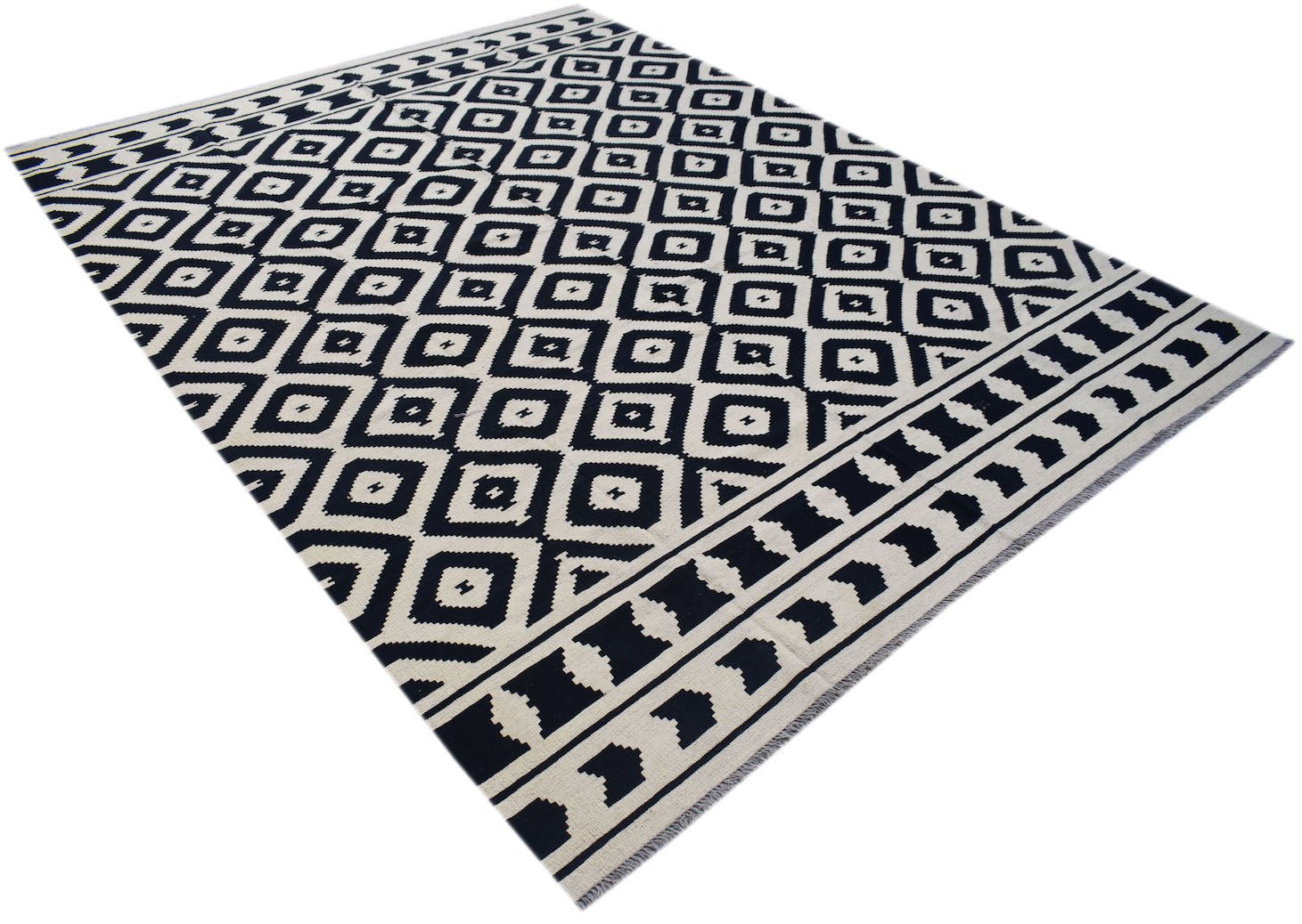 Handwoven Afghan Maimana kilim rug featuring a black and white geometric diamond pattern.