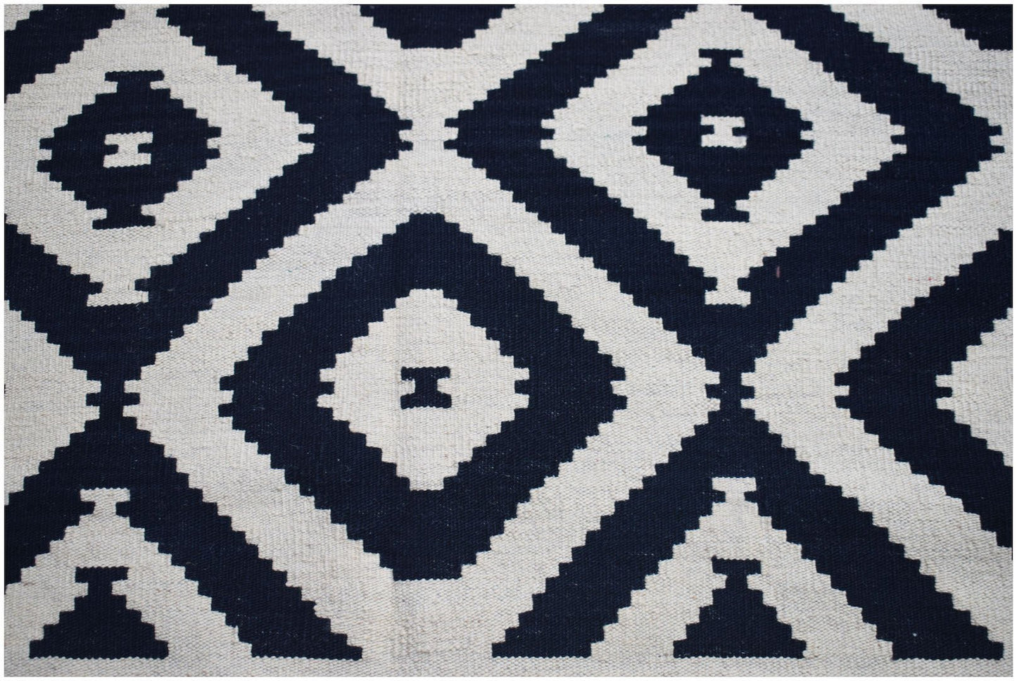 Afghan Maimana Kilim with a geometric diamond pattern in navy and cream.