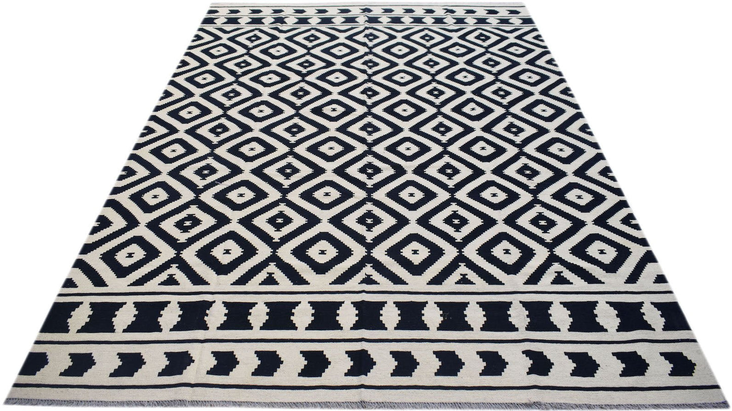 Handwoven Afghan Maimana kilim rug featuring a black and white geometric diamond pattern.