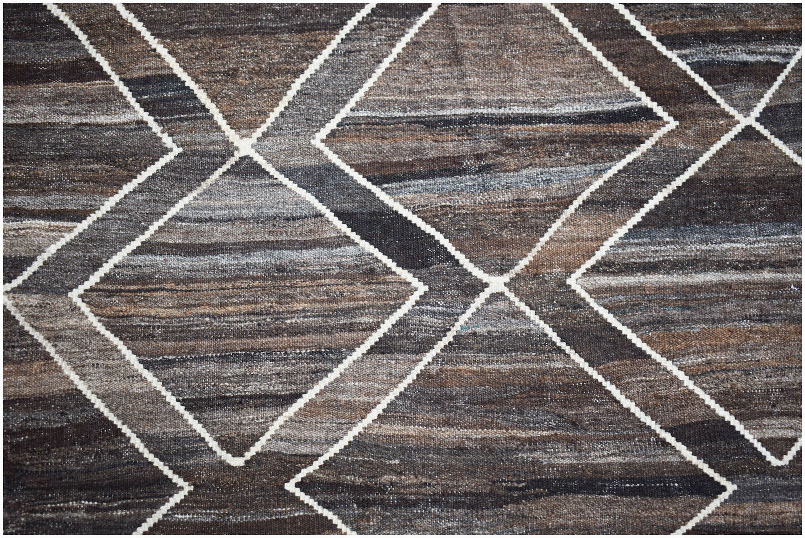 Handwoven Afghan Maimana kilim featuring a geometric diamond pattern in natural wool tones.