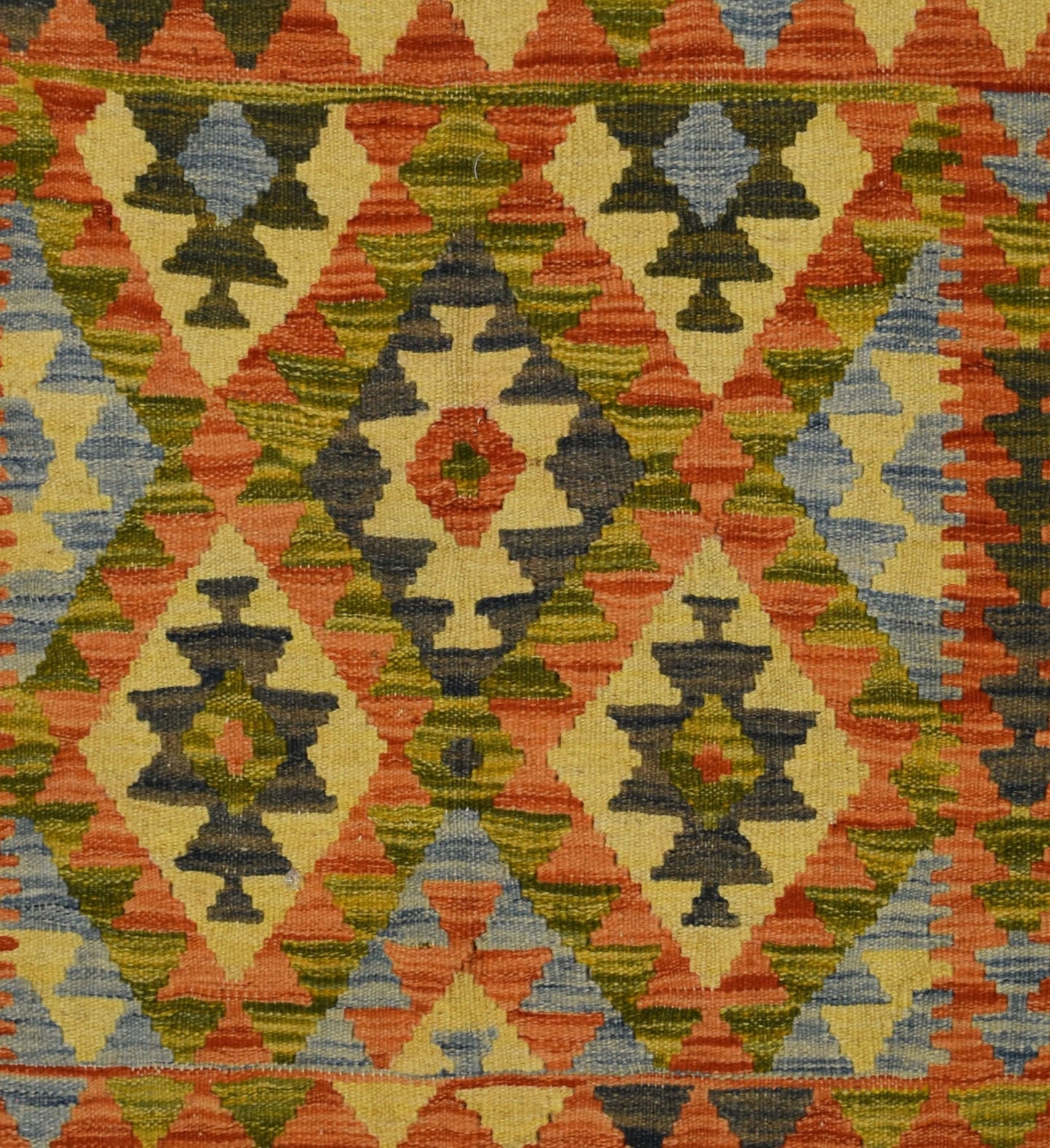 Handmade Afghan Maimana kilim rug featuring a geometric diamond pattern in warm, earthy tones.