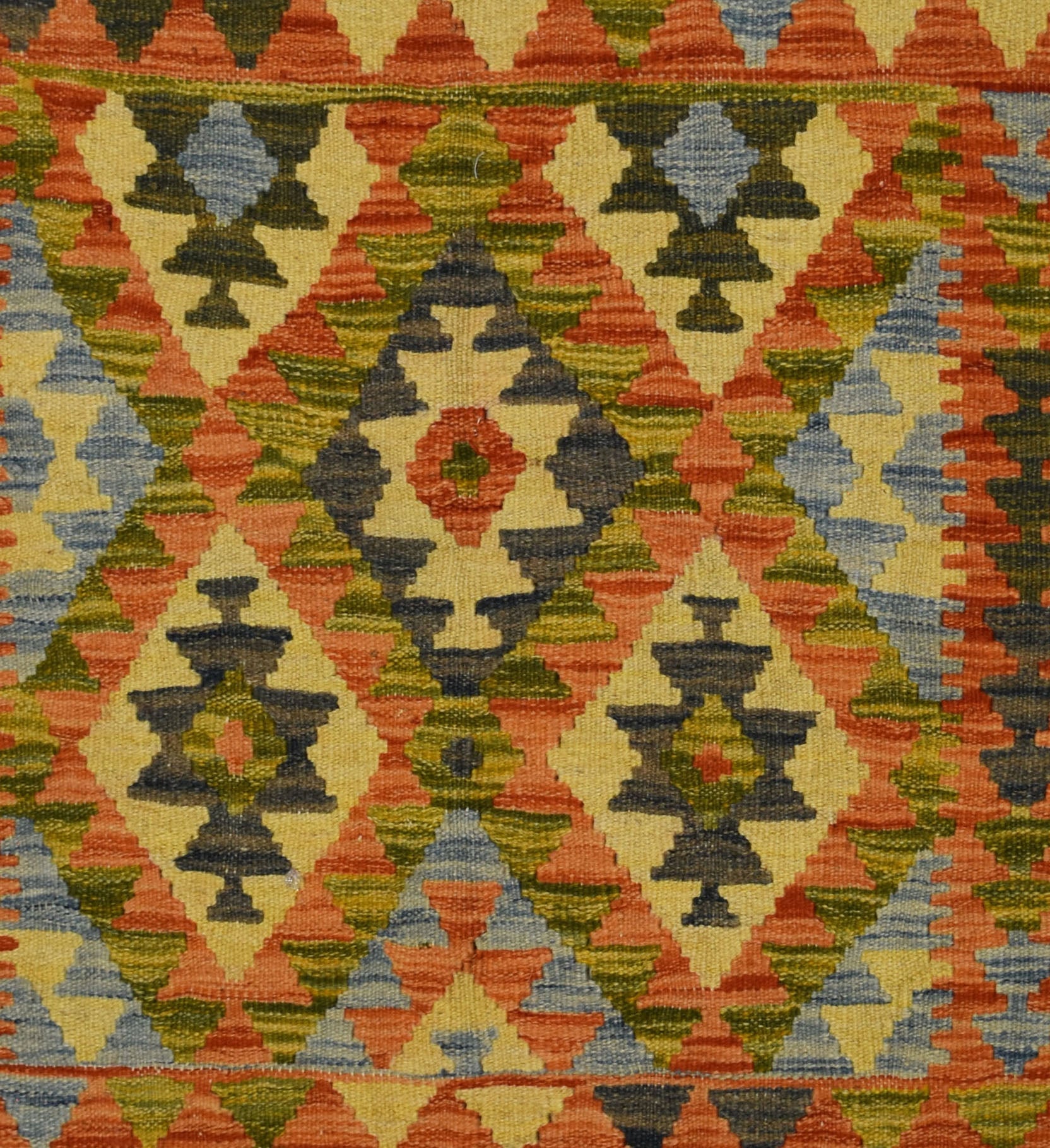 Handmade Afghan Maimana kilim rug featuring a geometric diamond pattern in warm, earthy tones.