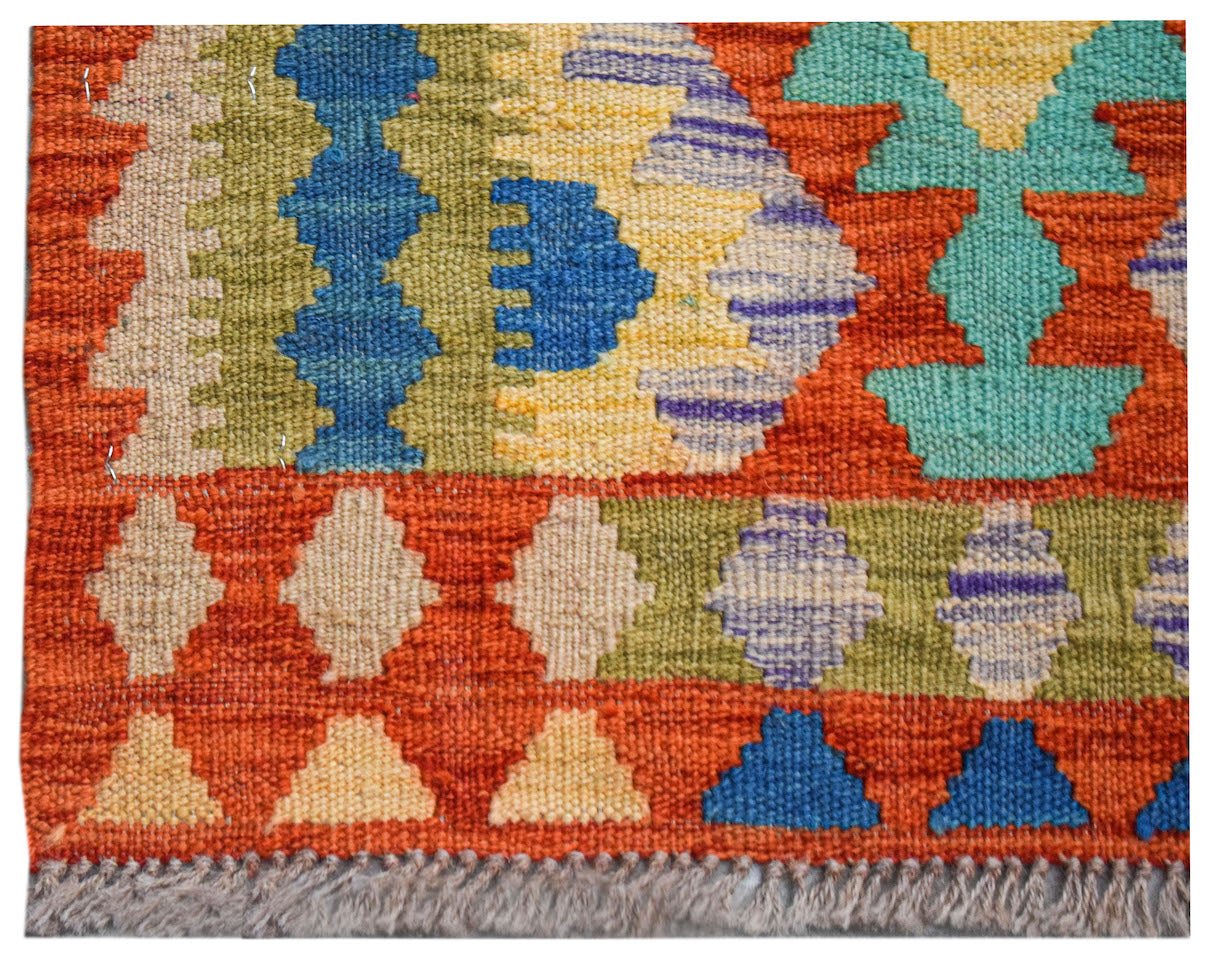 Handwoven Afghan Maimana wool kilim runner featuring a vibrant geometric pattern.