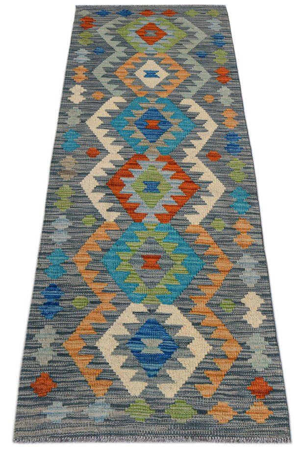 Handwoven Afghan Maimana wool runner featuring a geometric diamond pattern in vibrant colors.