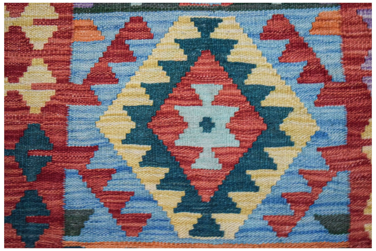 Handwoven Afghan Maimana wool runner featuring a geometric diamond pattern in vibrant colors.