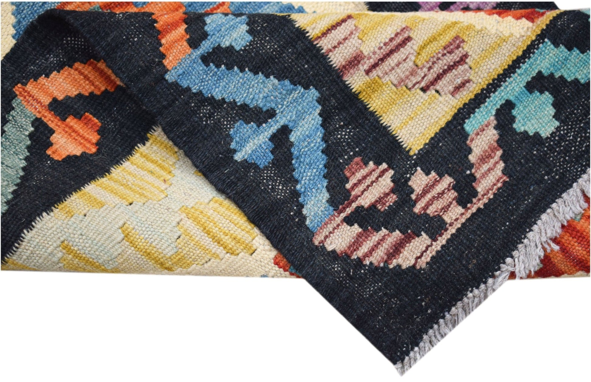 A handwoven Afghan Maimana kilim runner featuring a geometric pattern in vibrant wool colors.