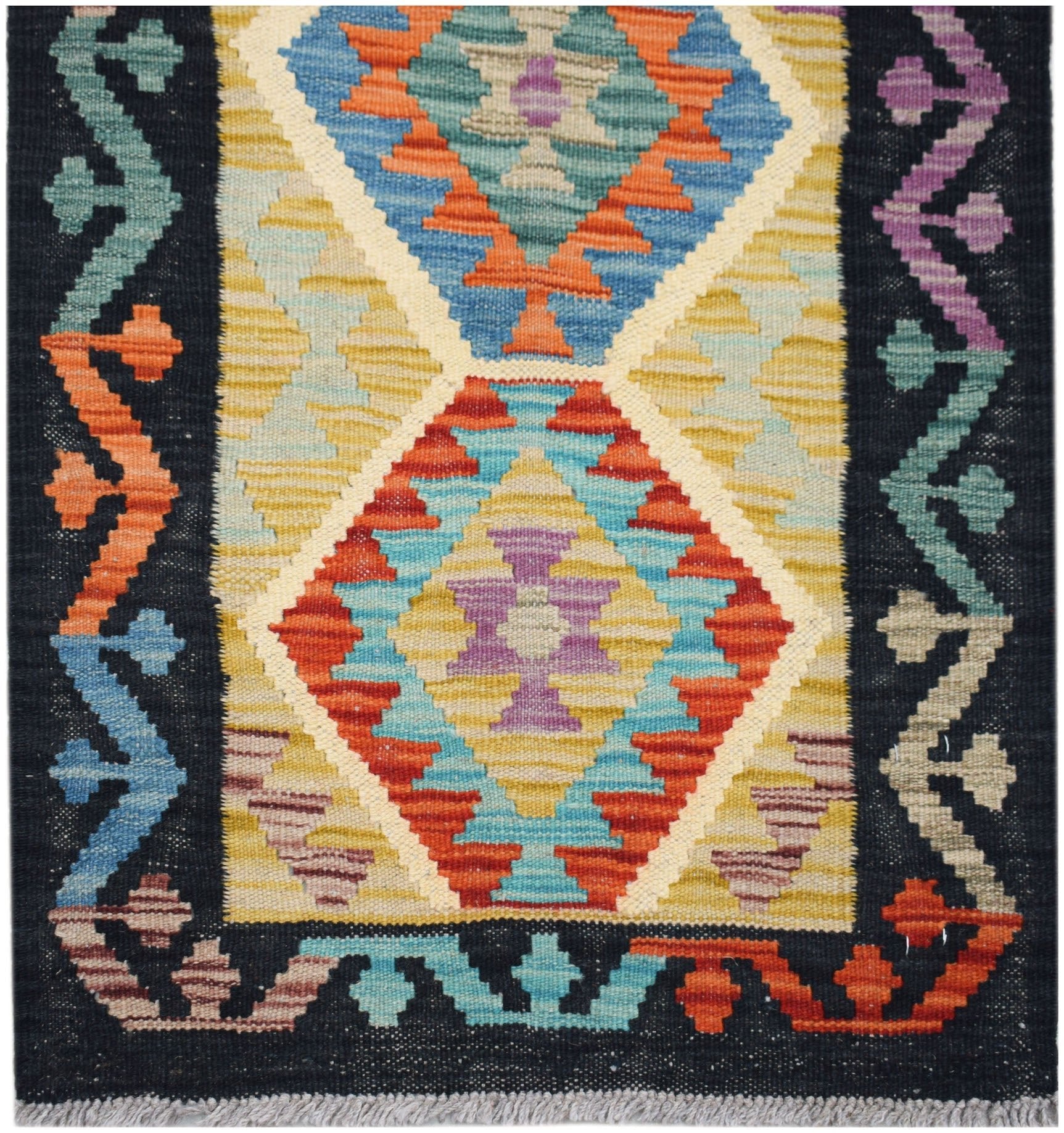 Handwoven Afghan Maimana wool runner featuring a geometric diamond pattern in vibrant colors.