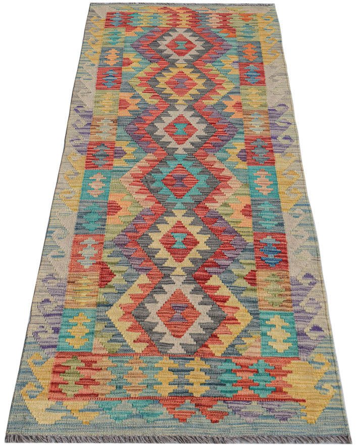Afghan Maimana Kilim runner with geometric patterns in multiple colors.