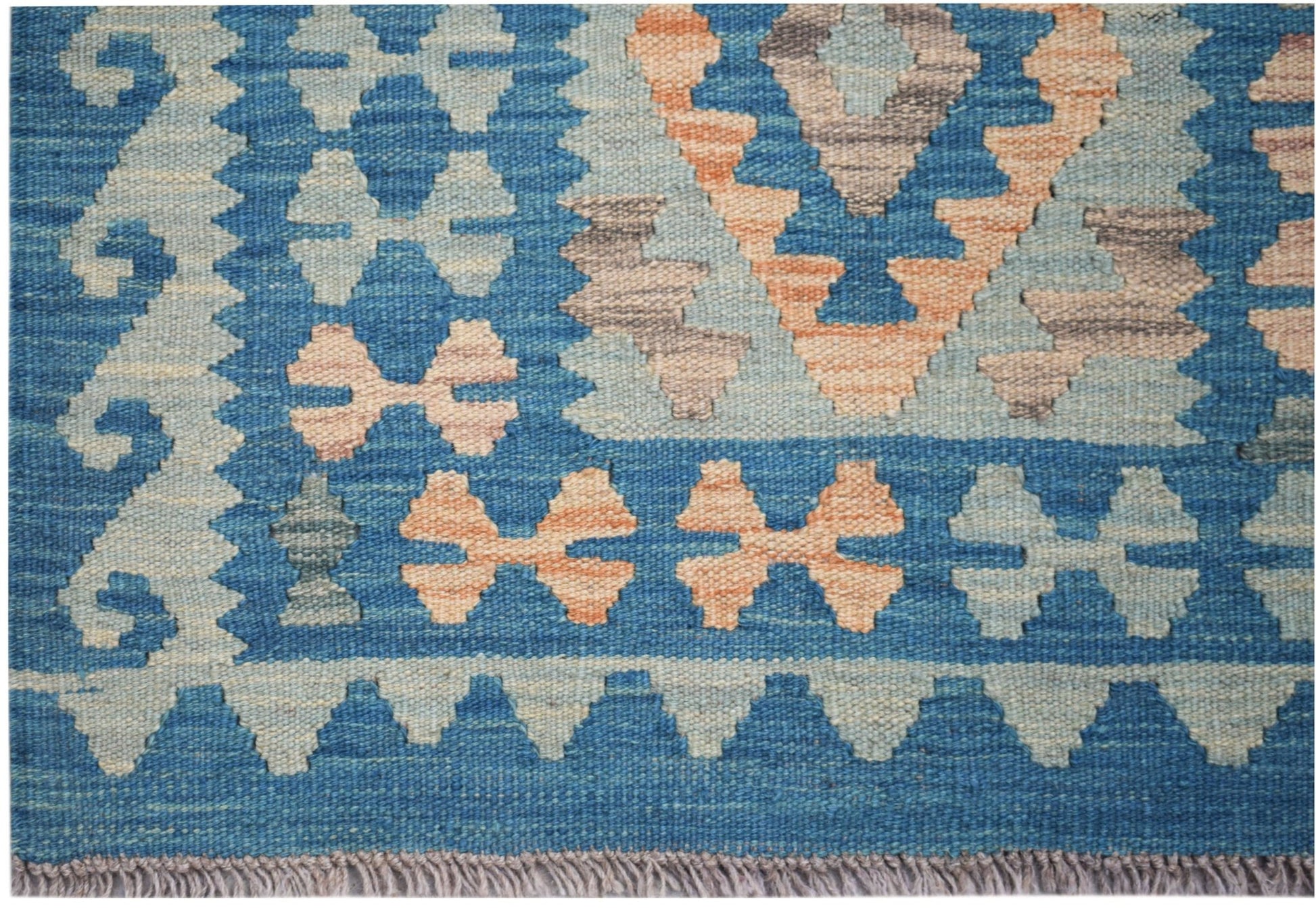 Handwoven Afghan Maimana wool runner featuring a blue background with geometric patterns.