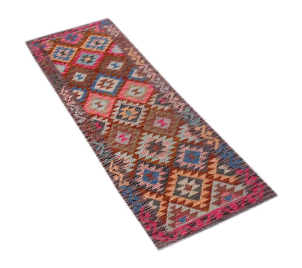 A handmade Afghan Maimana wool runner rug featuring a colorful geometric diamond pattern.