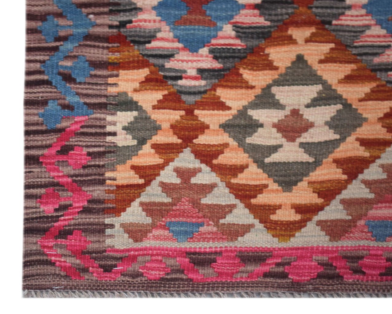 Handwoven Afghan Maimana wool runner featuring a geometric diamond pattern in vibrant colors.