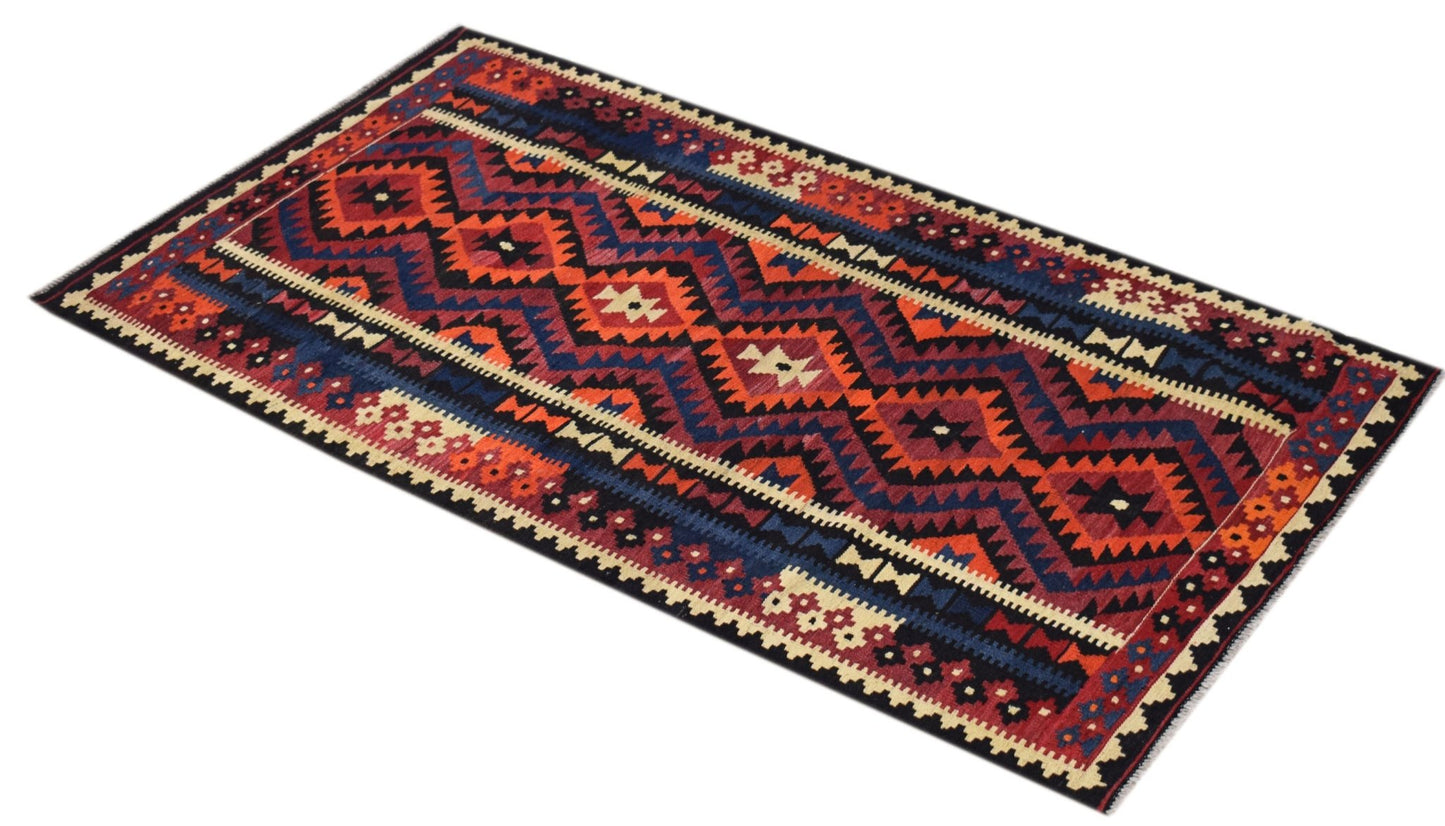 Handwoven Afghan Maimana wool runner rug featuring a geometric pattern in red and blue tones.