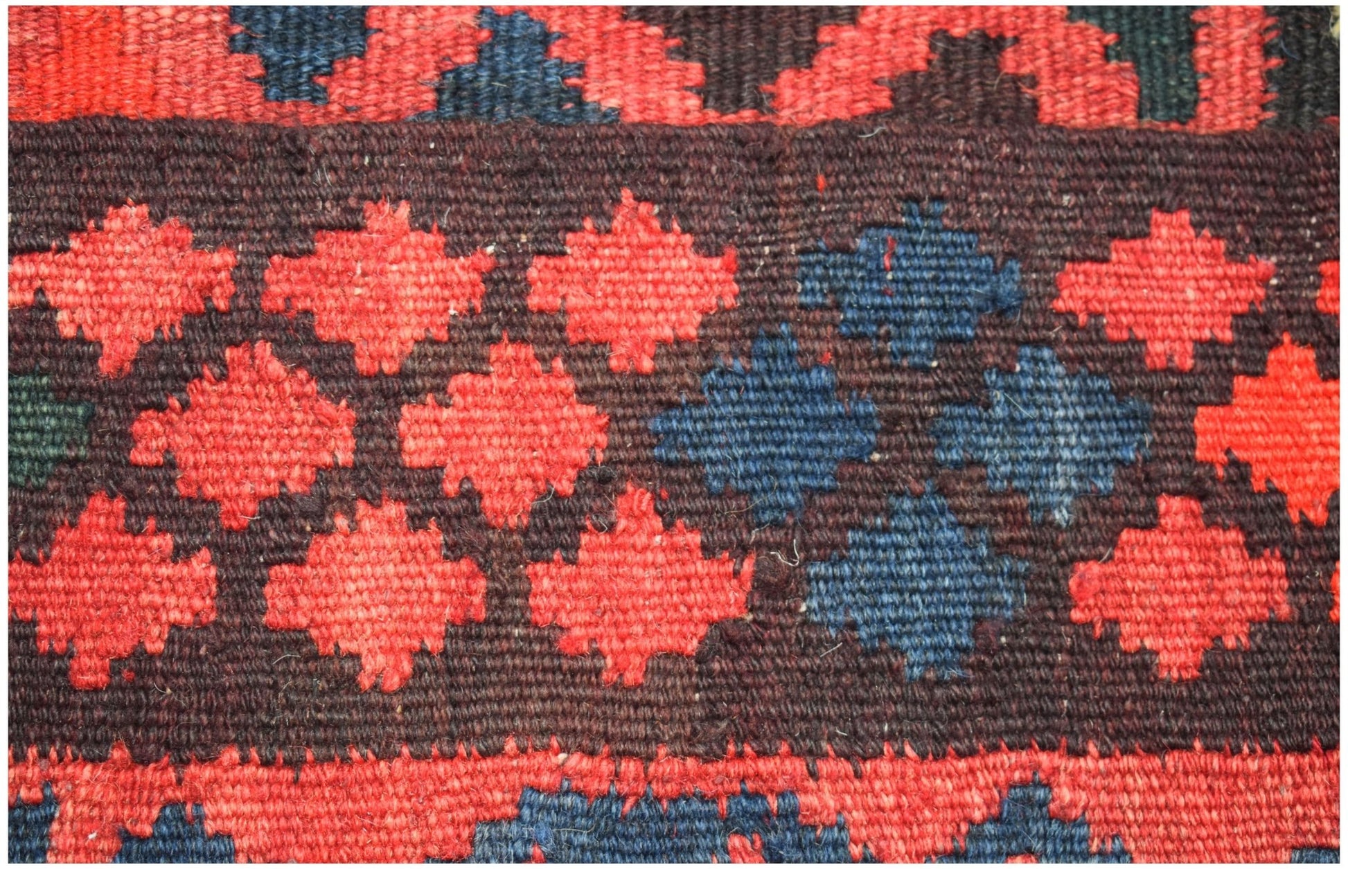 Handwoven Afghan Maimana kilim runner featuring a geometric pattern of red and blue diamonds.