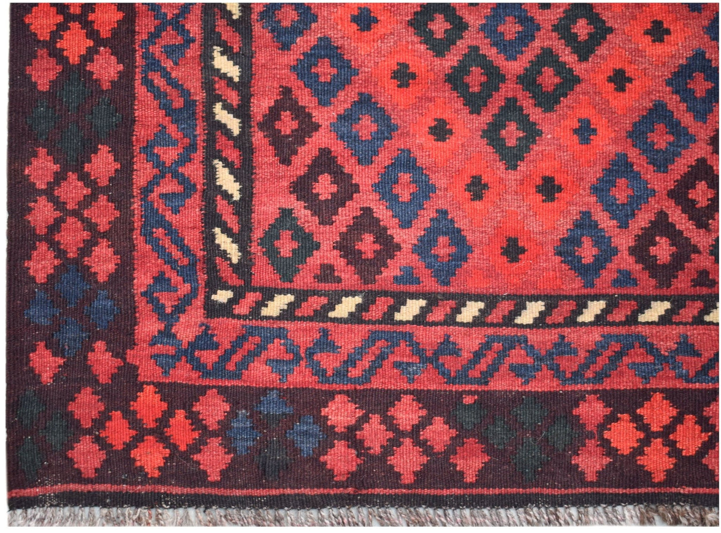 Handwoven Afghan Maimana wool kilim runner featuring a geometric diamond pattern in red and blue.