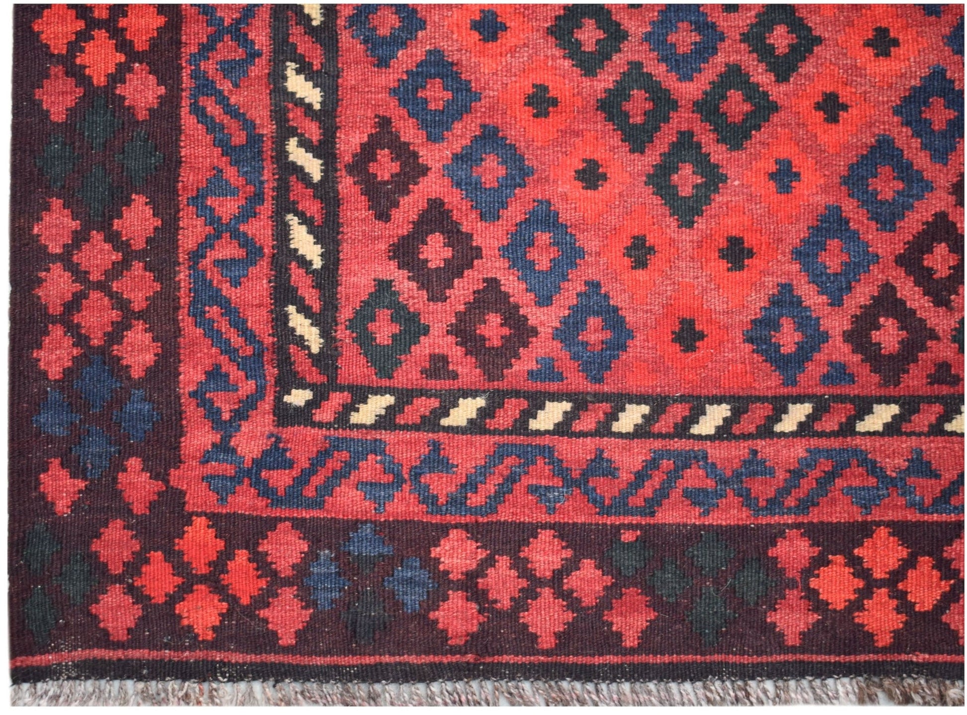 Handwoven Afghan Maimana wool kilim runner featuring a geometric diamond pattern in red and blue.