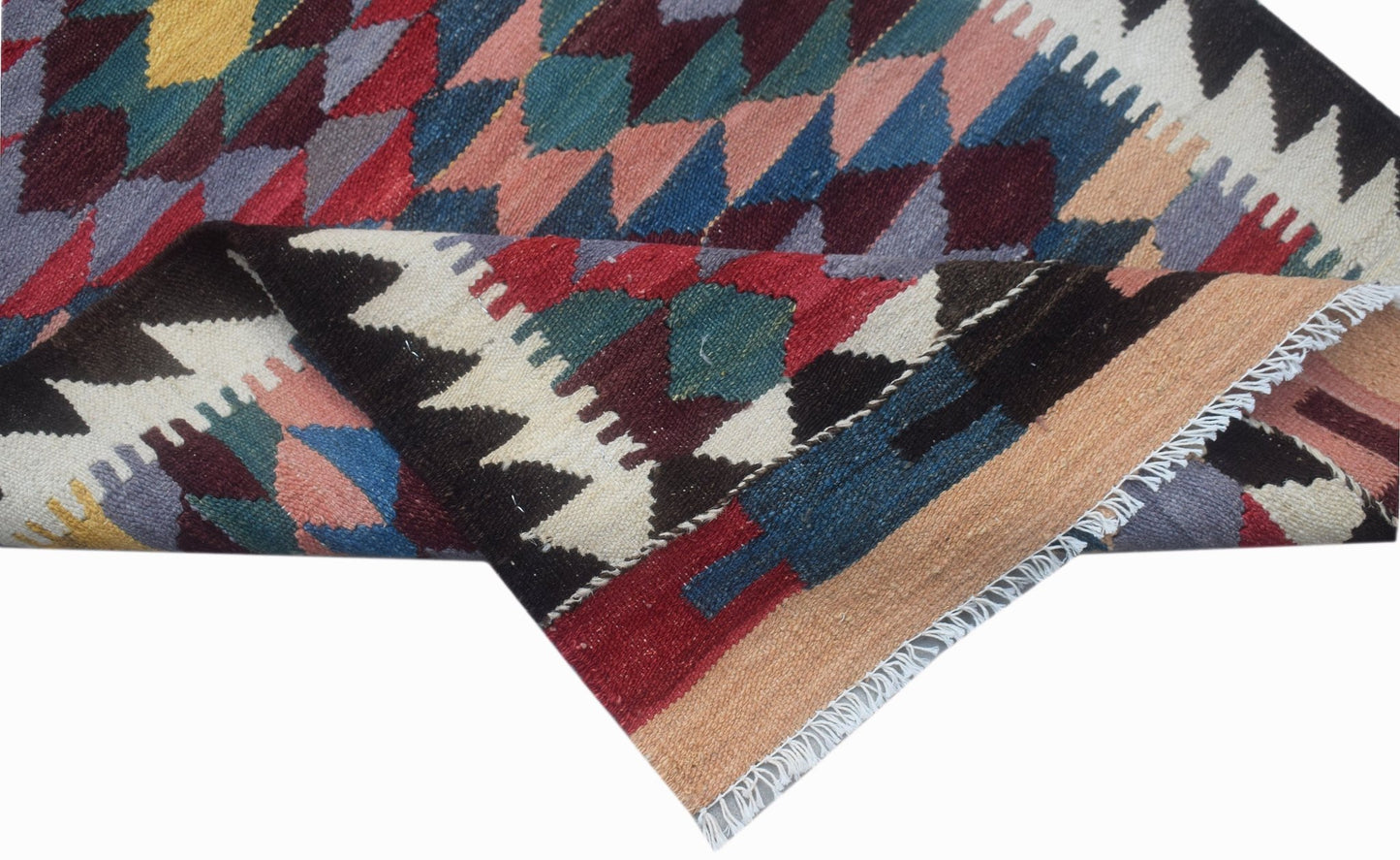 Handwoven Afghan Maimana wool runner featuring a colorful geometric pattern and fringed edges.