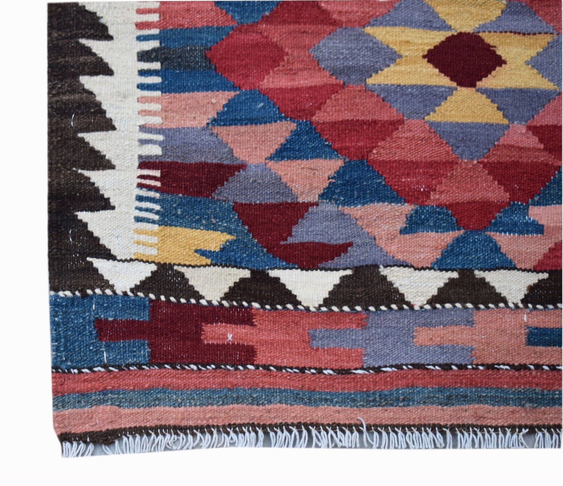 A handmade Afghan Maimana kilim runner featuring a geometric pattern in vibrant wool colors.