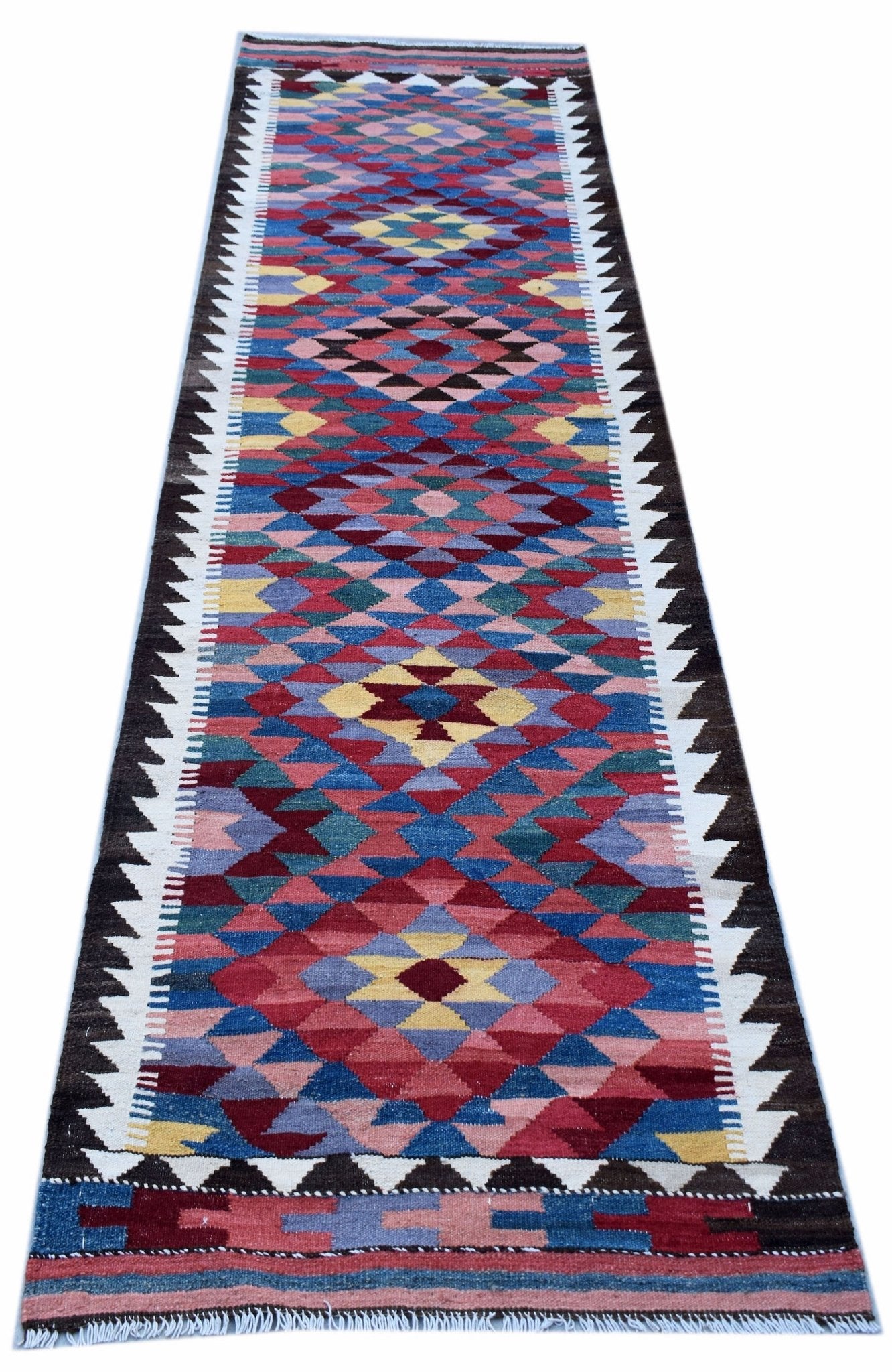 Handwoven Afghan Maimana wool runner rug featuring a colorful geometric diamond pattern.