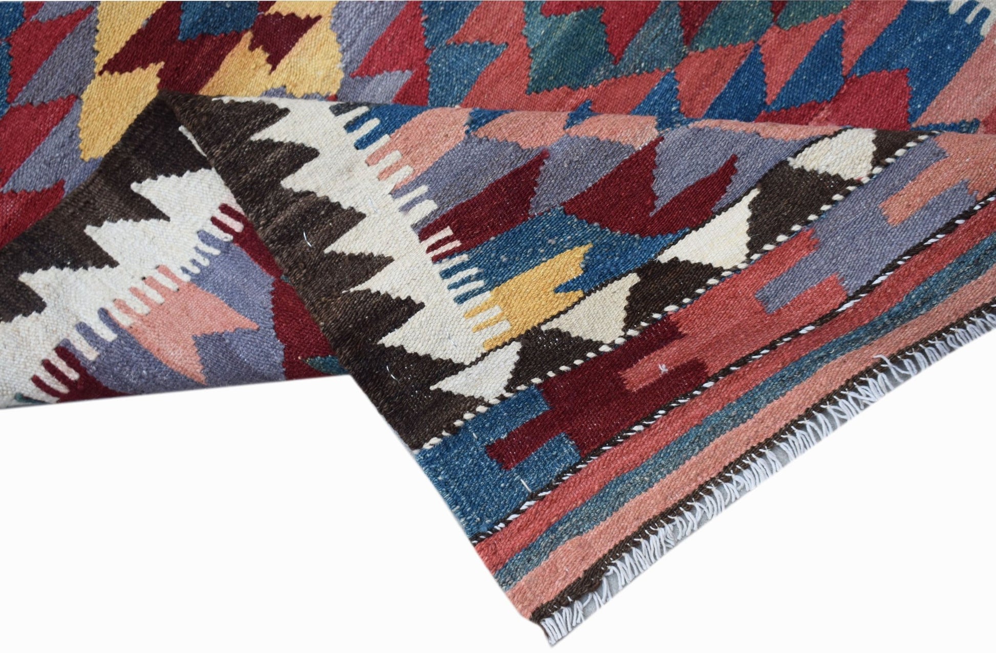 A handmade Afghan Maimana wool runner featuring a colorful geometric pattern.