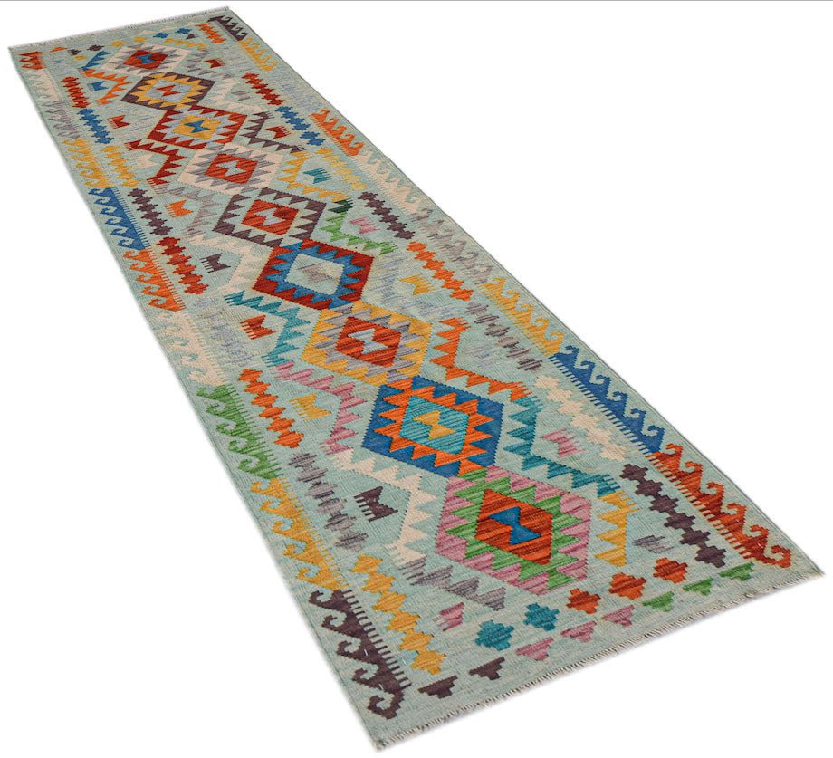 Afghan Maimana Kilim runner with geometric patterns in light blue and multicolor.