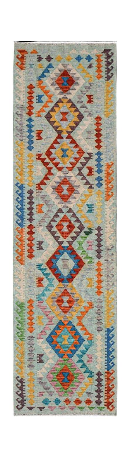 Handwoven Afghan Maimana wool runner rug featuring a light blue background and geometric patterns.