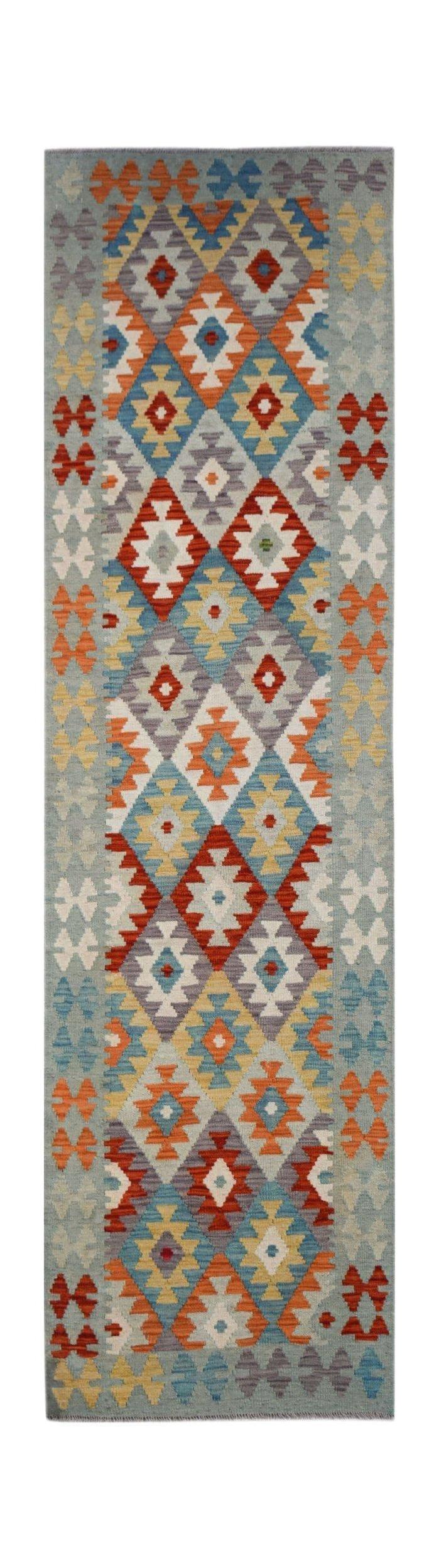Handwoven Afghan Maimana wool runner rug featuring a colorful geometric diamond pattern.