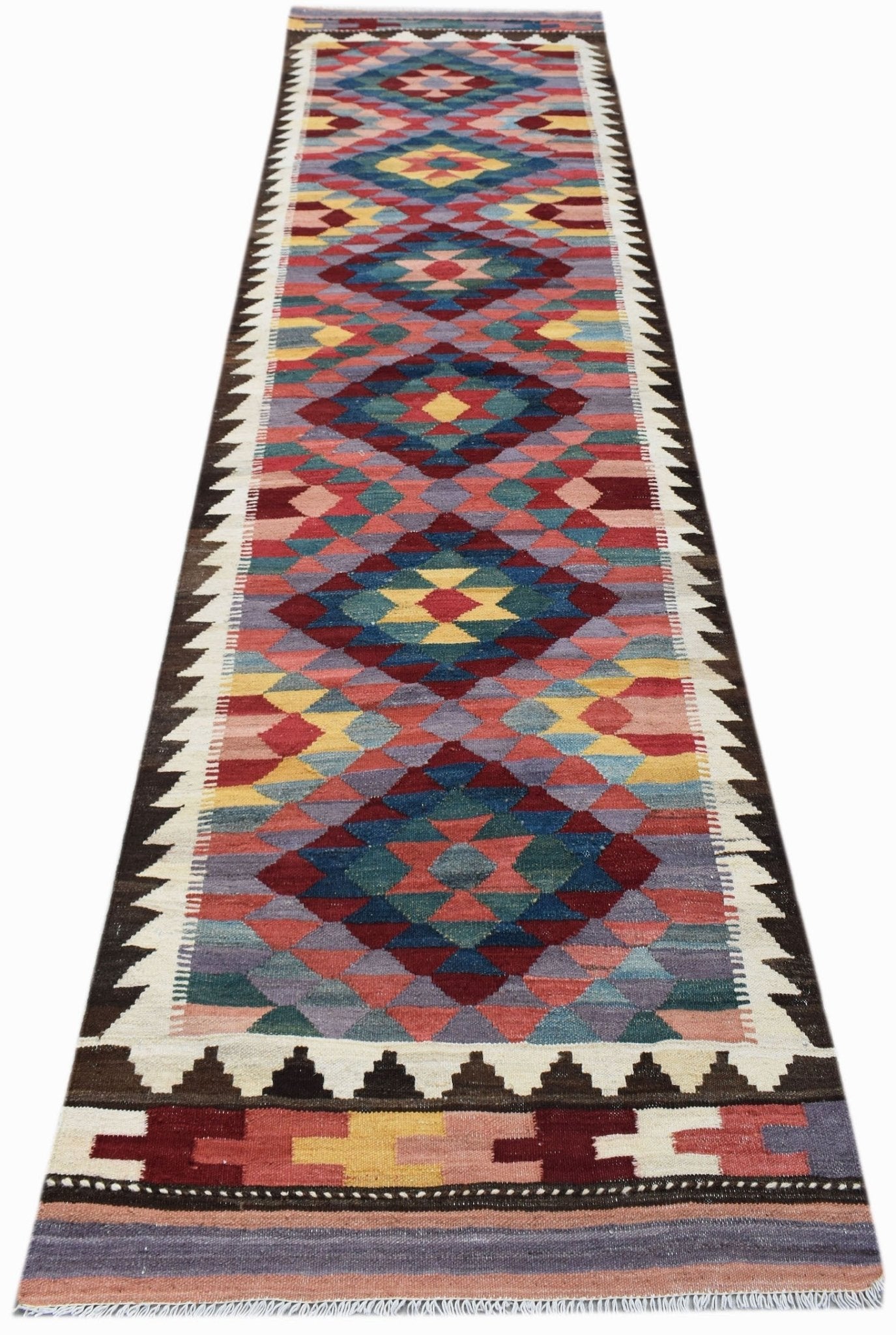 A handmade Afghan Maimana wool runner featuring a colorful geometric diamond pattern.