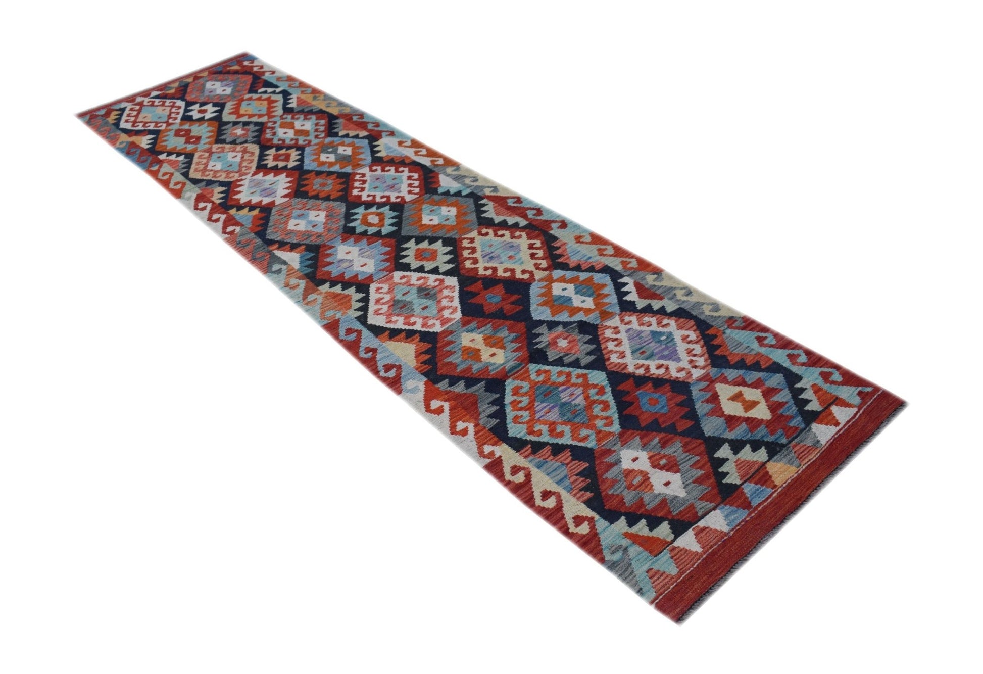 A handmade Afghan Maimana wool runner rug featuring a colorful geometric diamond pattern.