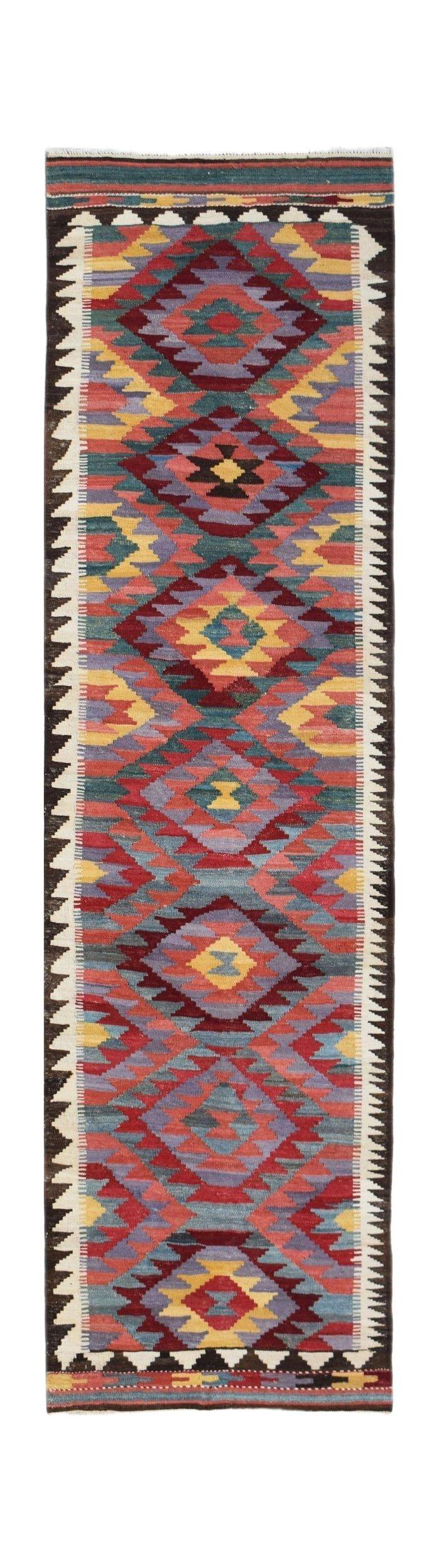Handwoven Afghan Maimana wool runner rug featuring a colorful geometric diamond pattern.