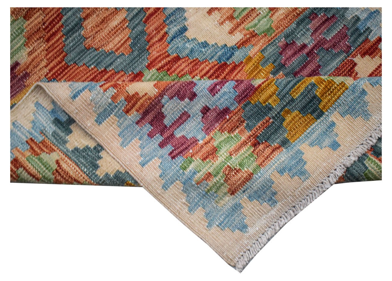 Handwoven Afghan Maimana wool kilim runner featuring a colorful geometric pattern.