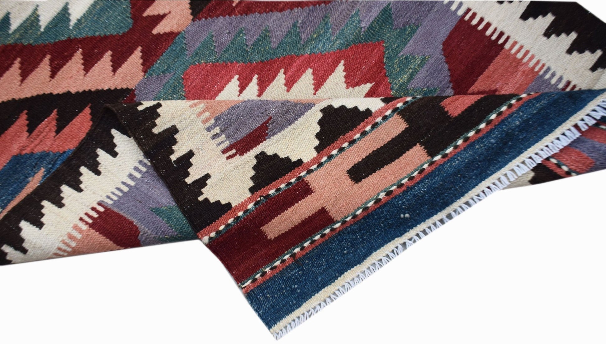 A handmade Afghan Maimana kilim runner featuring geometric patterns in red, blue, and purple wool.