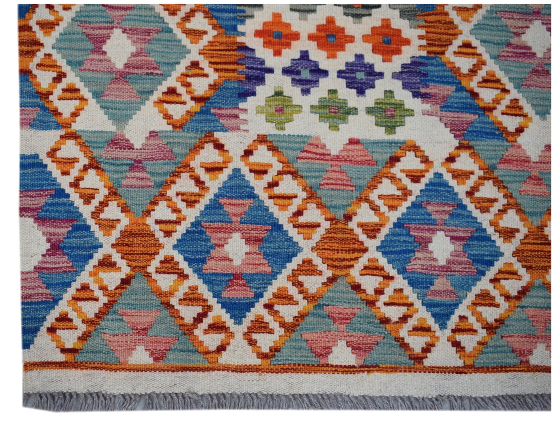 Handwoven Afghan Maimana wool runner featuring a colorful geometric diamond pattern and fringe.