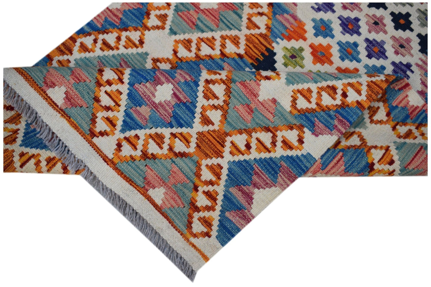 Handwoven Afghan Maimana wool runner featuring a colorful geometric pattern and fringed edges.