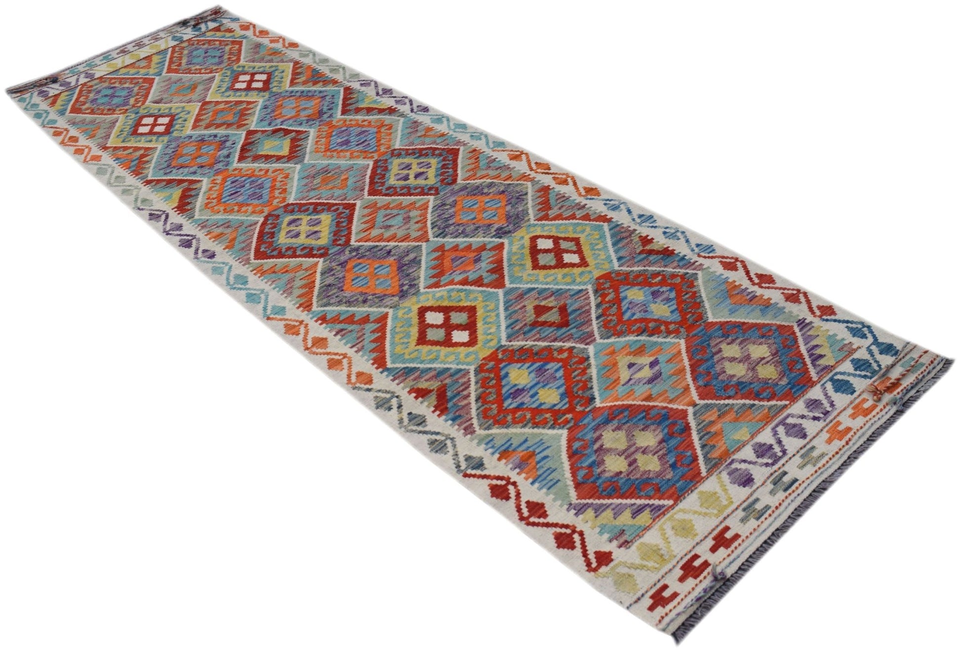 A handmade Afghan Maimana wool runner rug featuring a colorful geometric diamond pattern.