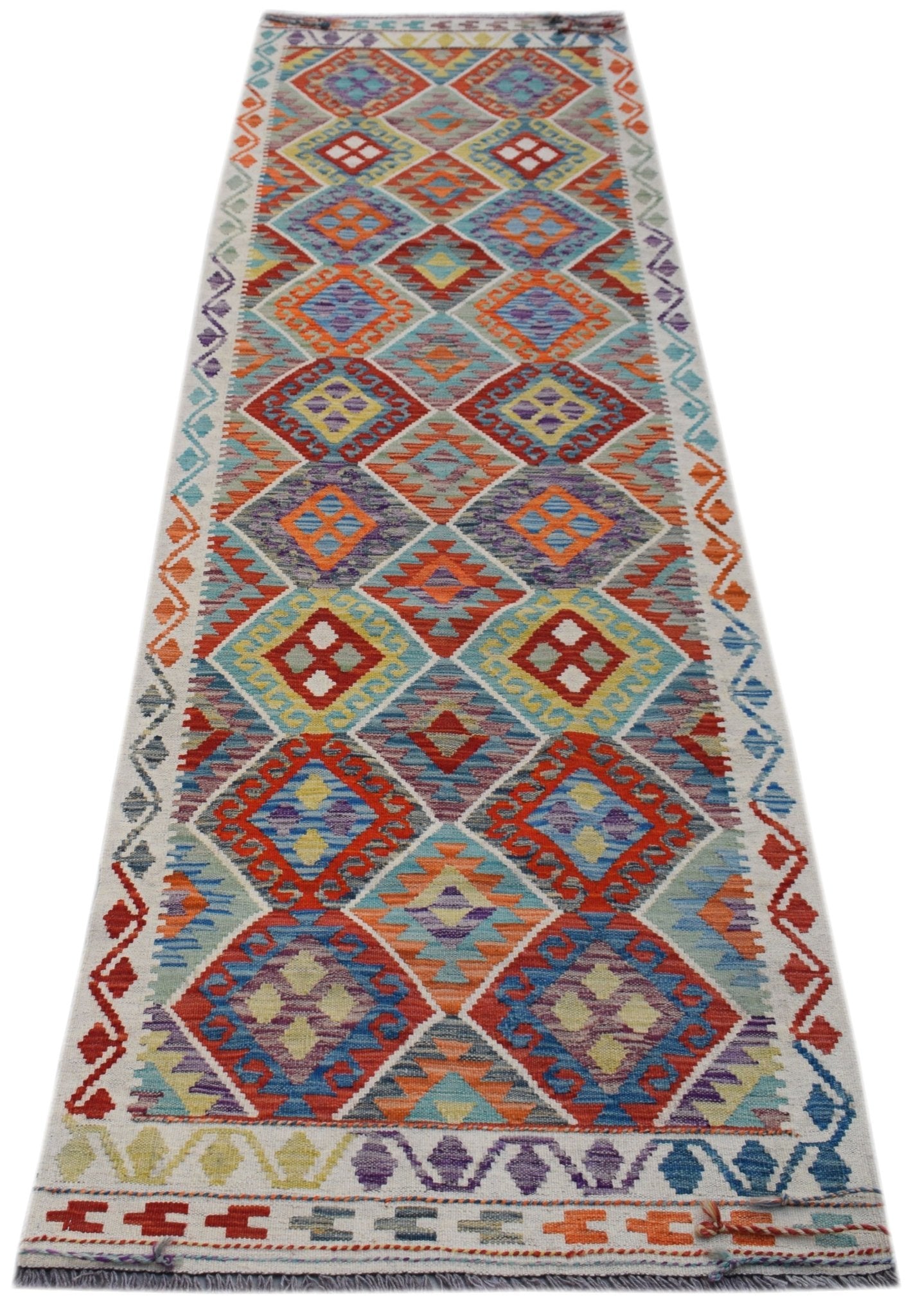 A handmade Afghan Maimana wool runner rug featuring a colorful geometric diamond pattern.