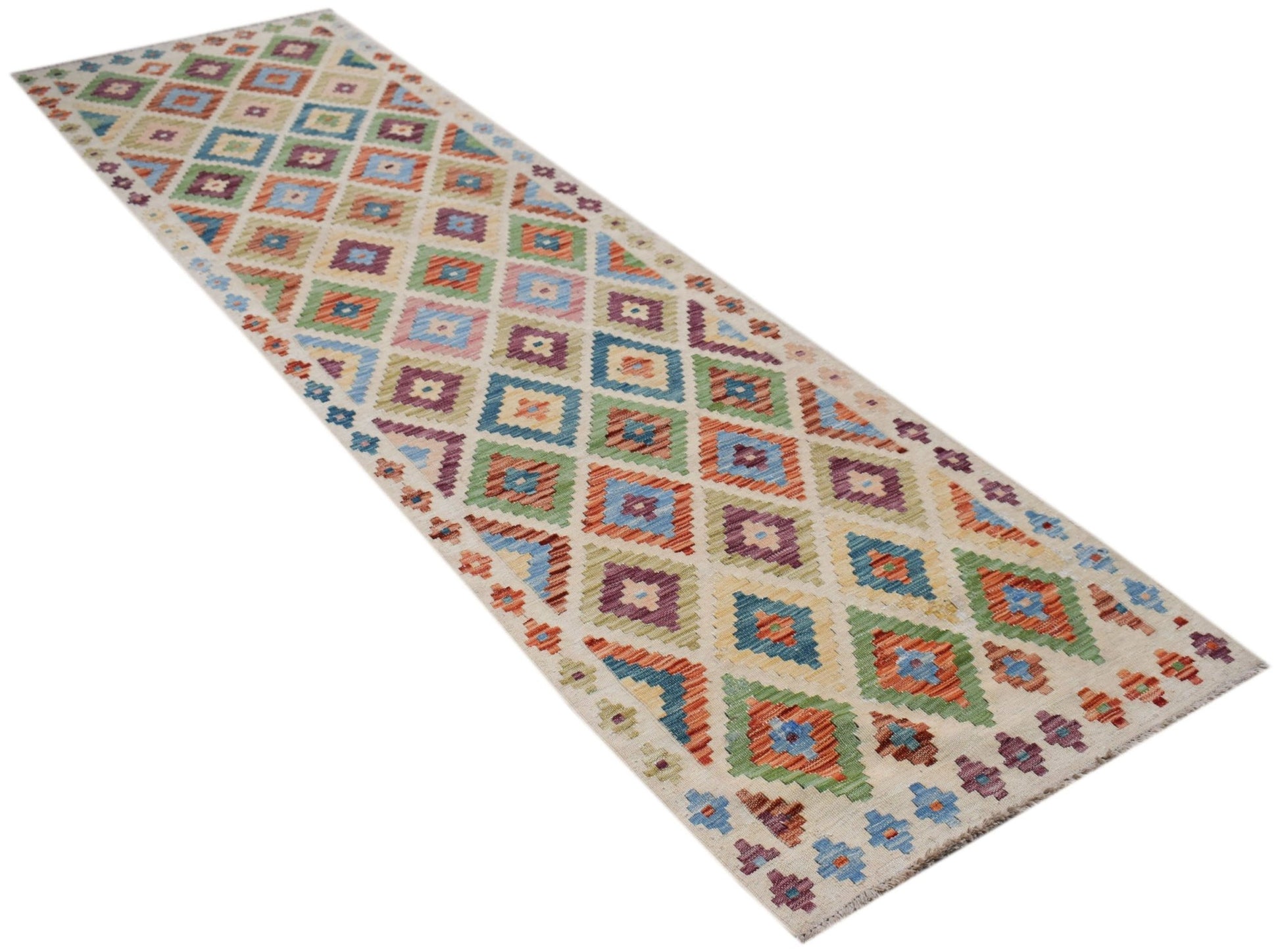 A handmade Afghan Maimana wool runner featuring a colorful geometric diamond pattern.