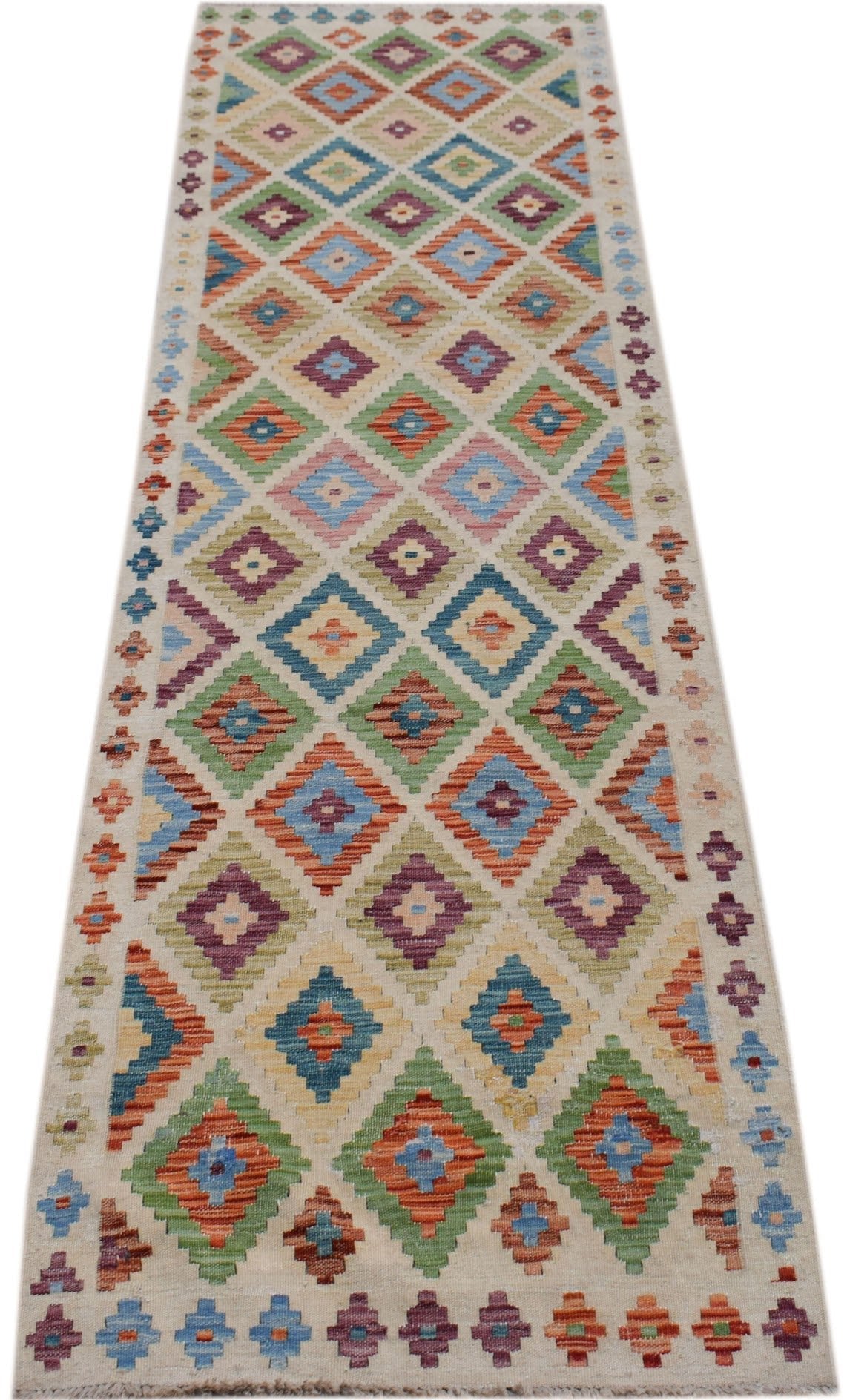 Handwoven Afghan Maimana wool runner rug featuring a colorful geometric diamond pattern.