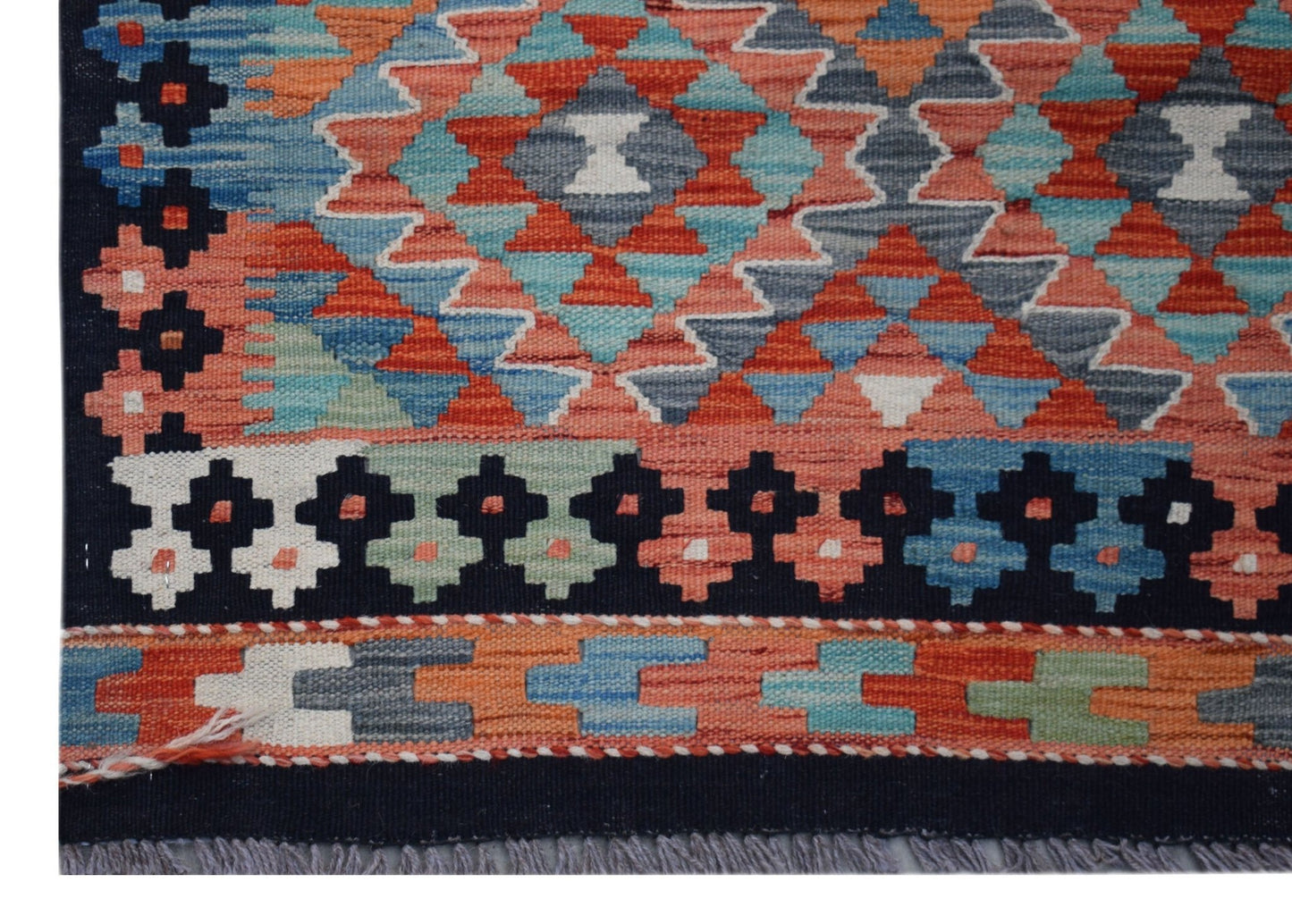 Handwoven Afghan Maimana wool runner featuring a geometric pattern in vibrant multicolored tones.