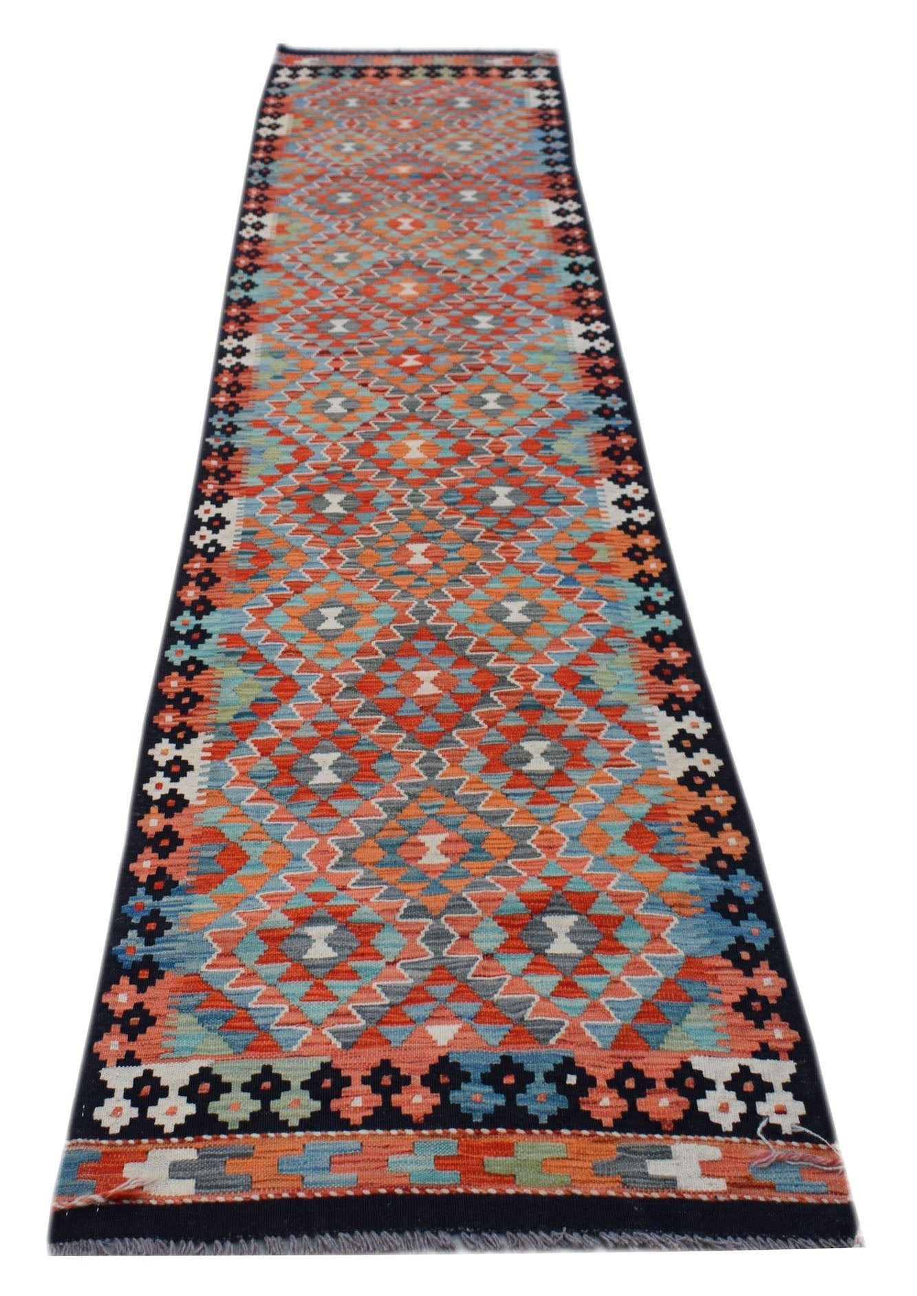 A handmade Afghan Maimana wool runner rug featuring a colorful geometric diamond pattern.
