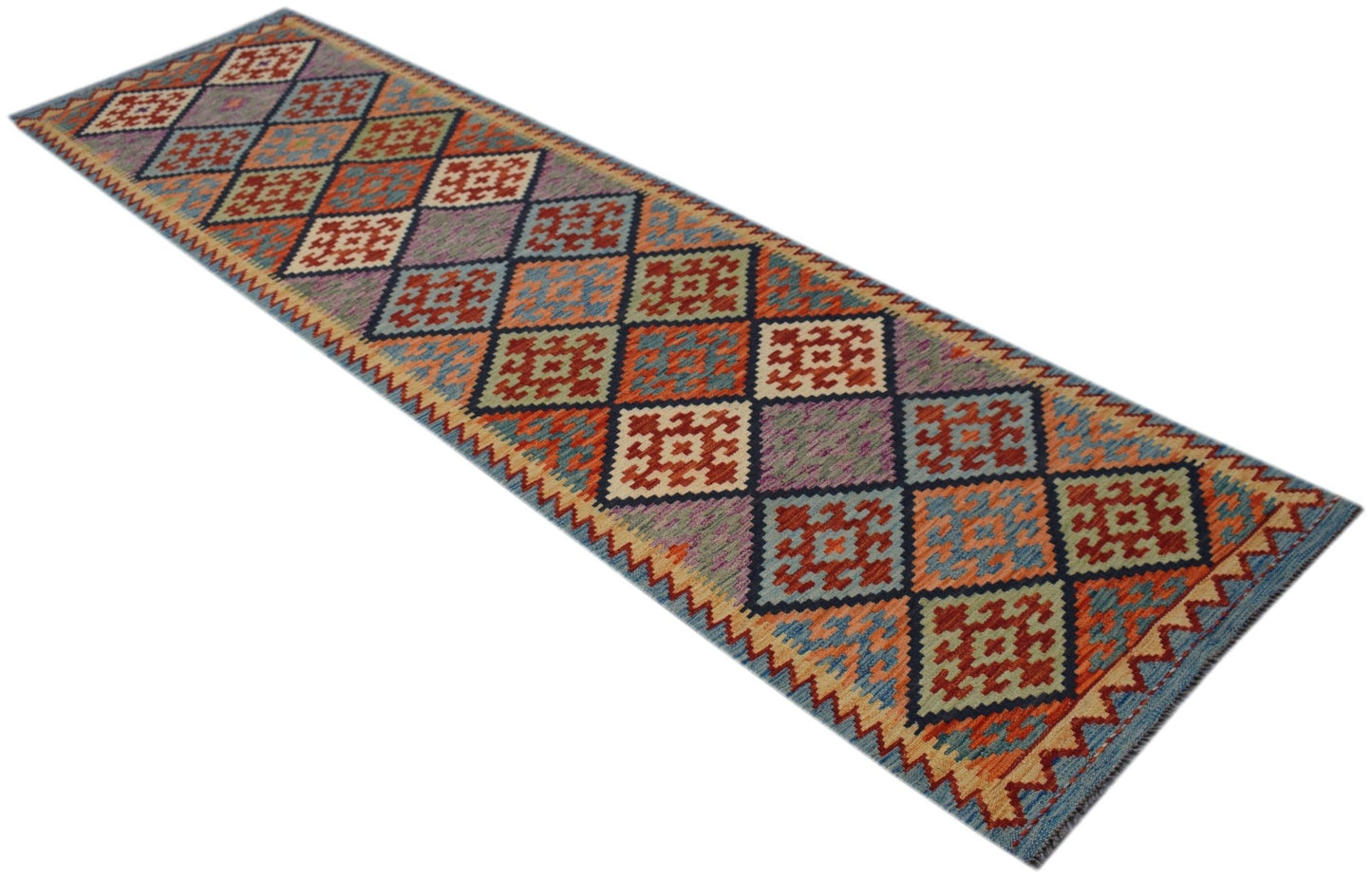A handmade Afghan Maimana wool runner rug featuring a colorful geometric diamond pattern.