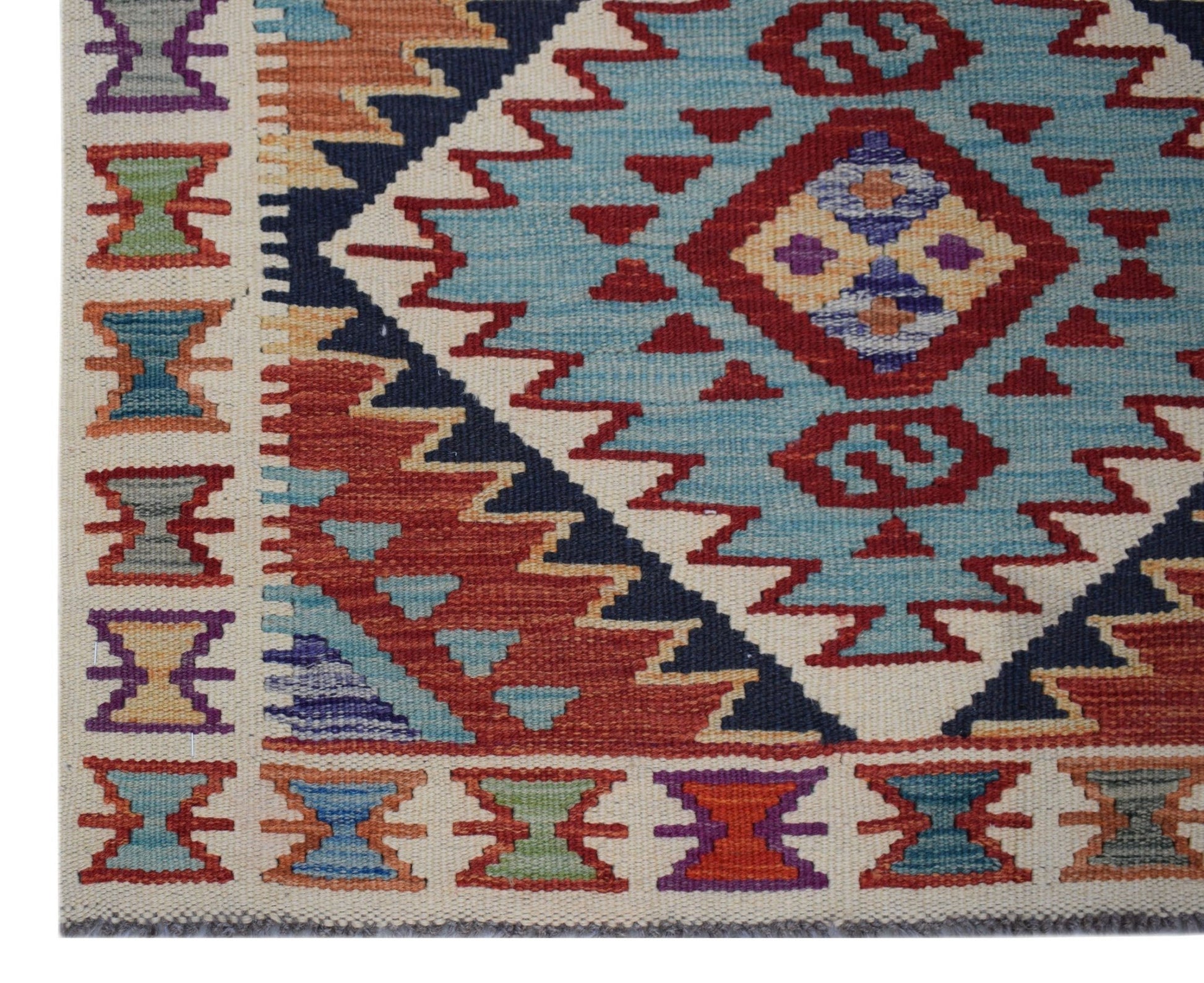 Handwoven Afghan Maimana wool runner featuring a geometric pattern in blue, red, and cream tones.
