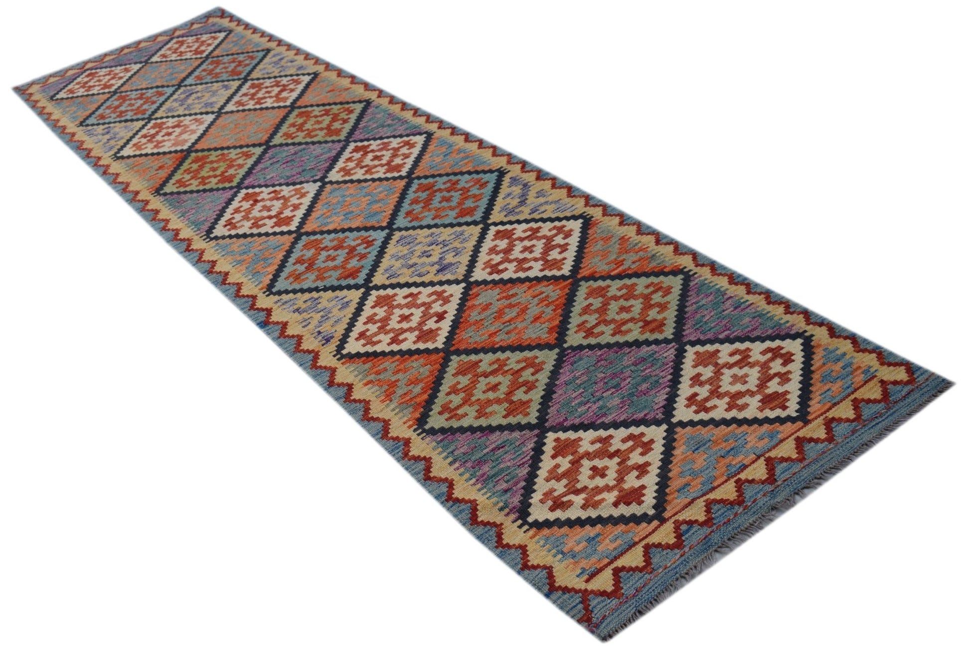 A handmade Afghan Maimana wool runner rug featuring a colorful geometric diamond pattern.