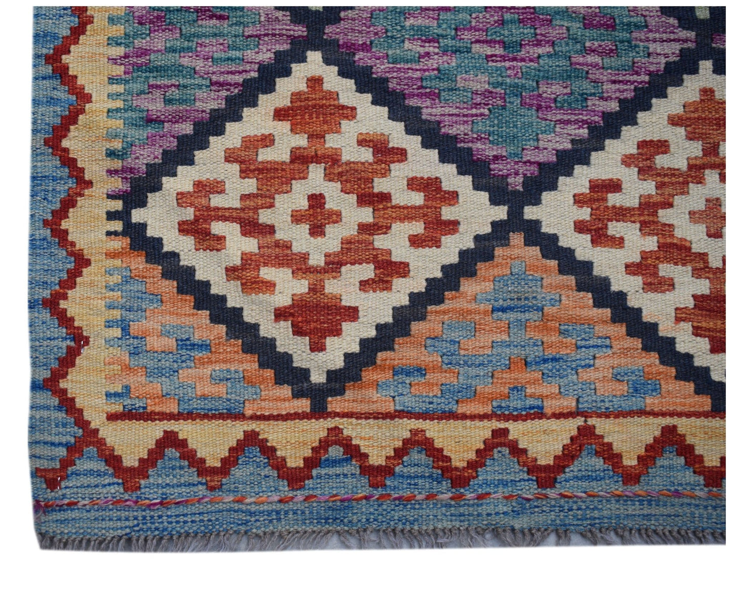Handwoven Afghan Maimana wool runner featuring a geometric diamond pattern in vibrant colors.